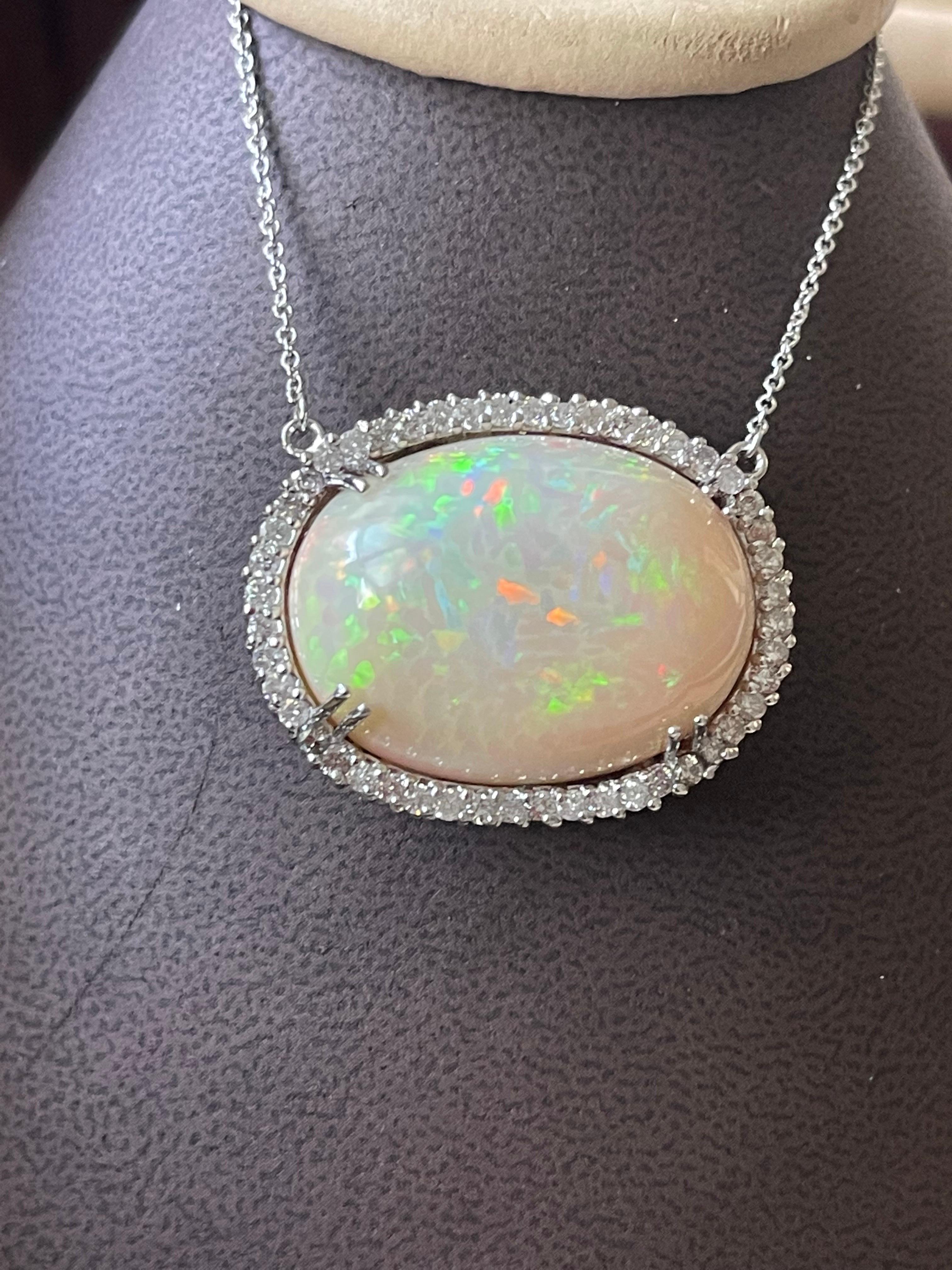 Approximately 42 Carat Oval Ethiopian Opal  & Diamond Pendant 14 Karat White Gold Necklace with Chain
This spectacular Pendant Necklace consisting of a single Oval Shape Ethiopian Opal Approximately 42 Carat. 
28 X20 MM size of opal
very clean Stone
