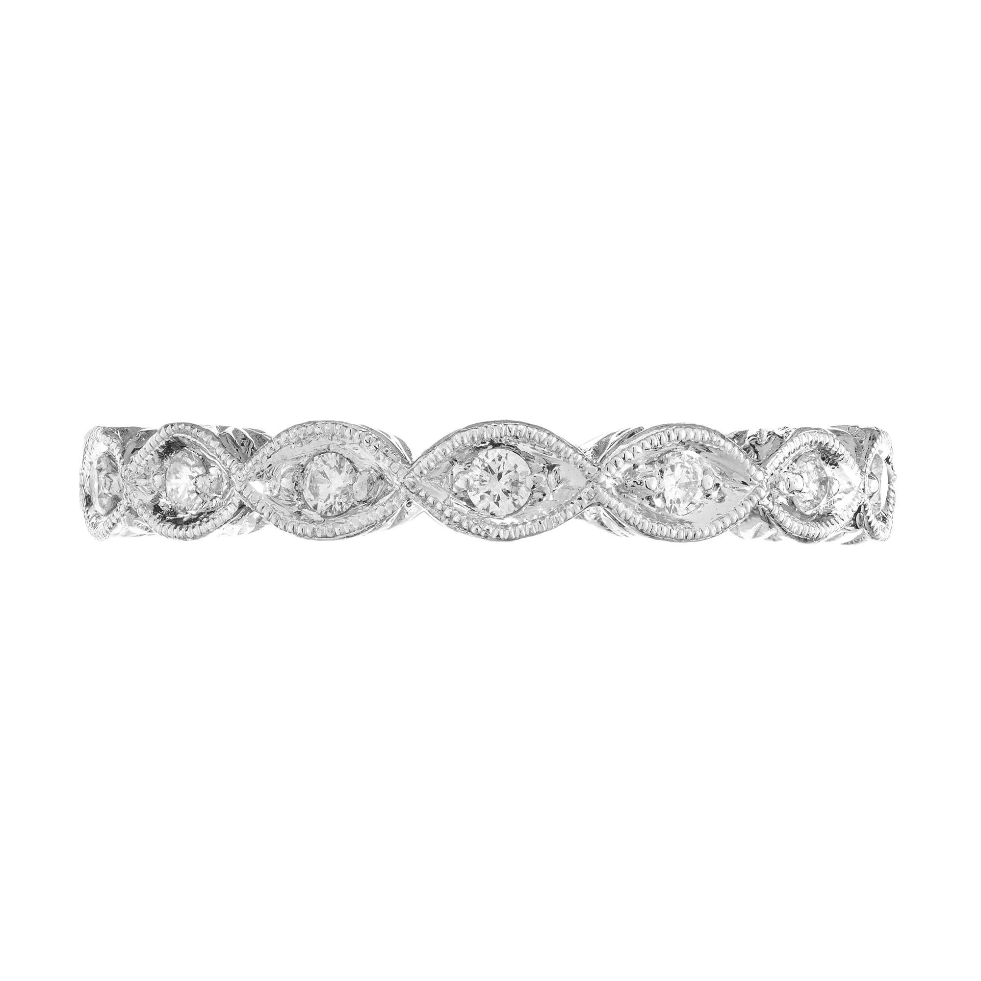 Crafted to perfection, this timeless diamond wedding band showcases a dazzling row of 14 round brilliant cut diamonds set in a lustrous platinum mounting. Beautifully hand beaded with detailed engraving. The diamonds are mounted in marquise shaped