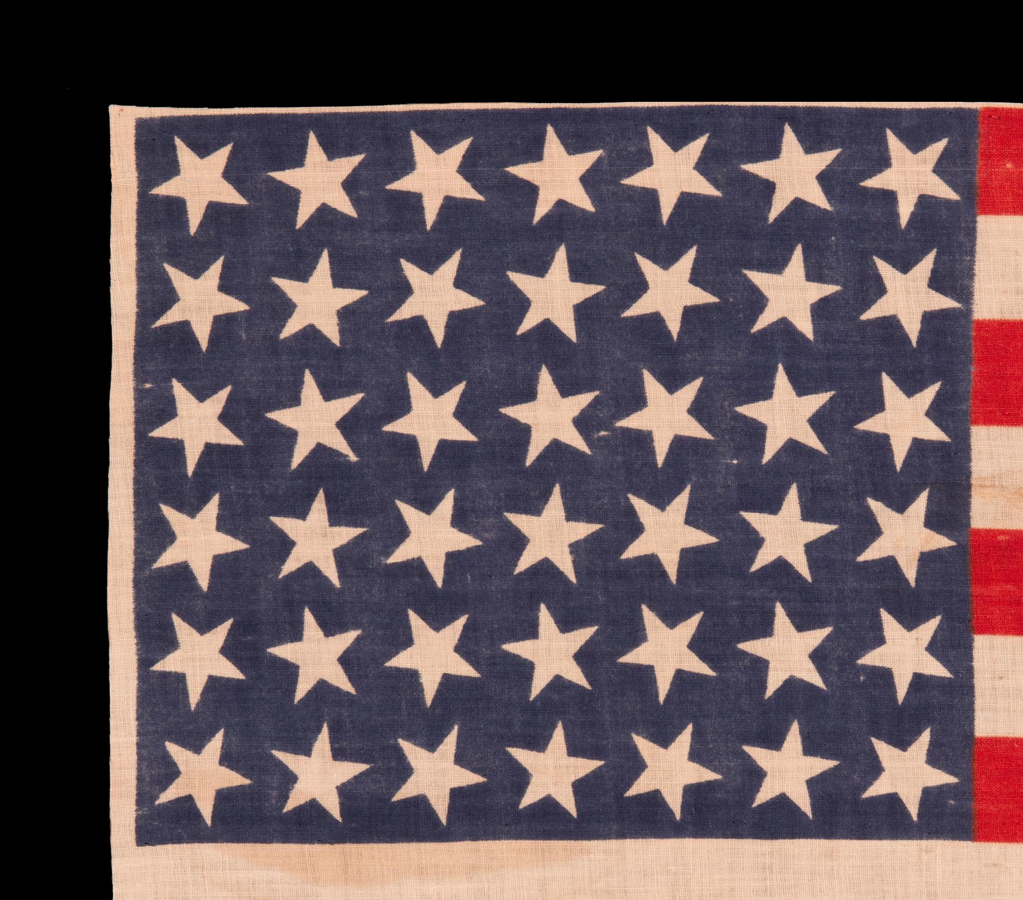 42 STARS ON AN ANTIQUE AMERICAN FLAG WITH SCATTERED STAR POSITIONING, REFLECTS THE ADDITION OF WASHINGTON STATE, MONTANA, AND THE DAKOTAS, NEVER AN OFFICIAL STAR COUNT, circa 1889-1890

42 star parade flag, printed on plain weave cotton. The stars