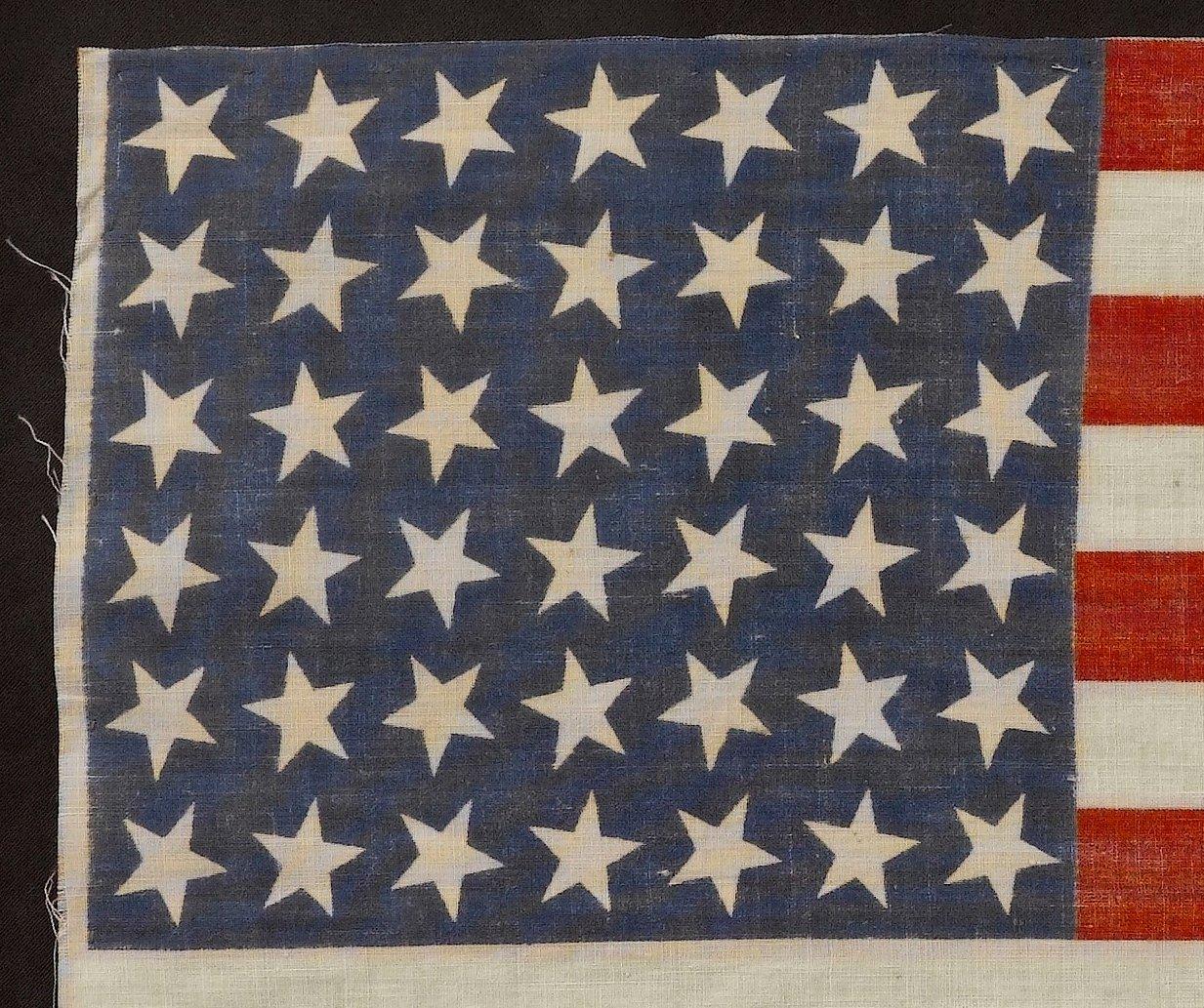 This is an uncommon 42-star flag, commemorating the addition of the state of Washington to the Union. The flag dates to 1889-1890, and is printed on cotton. The canton consists of six rows of seven dancing stars, which is an unusual star pattern.