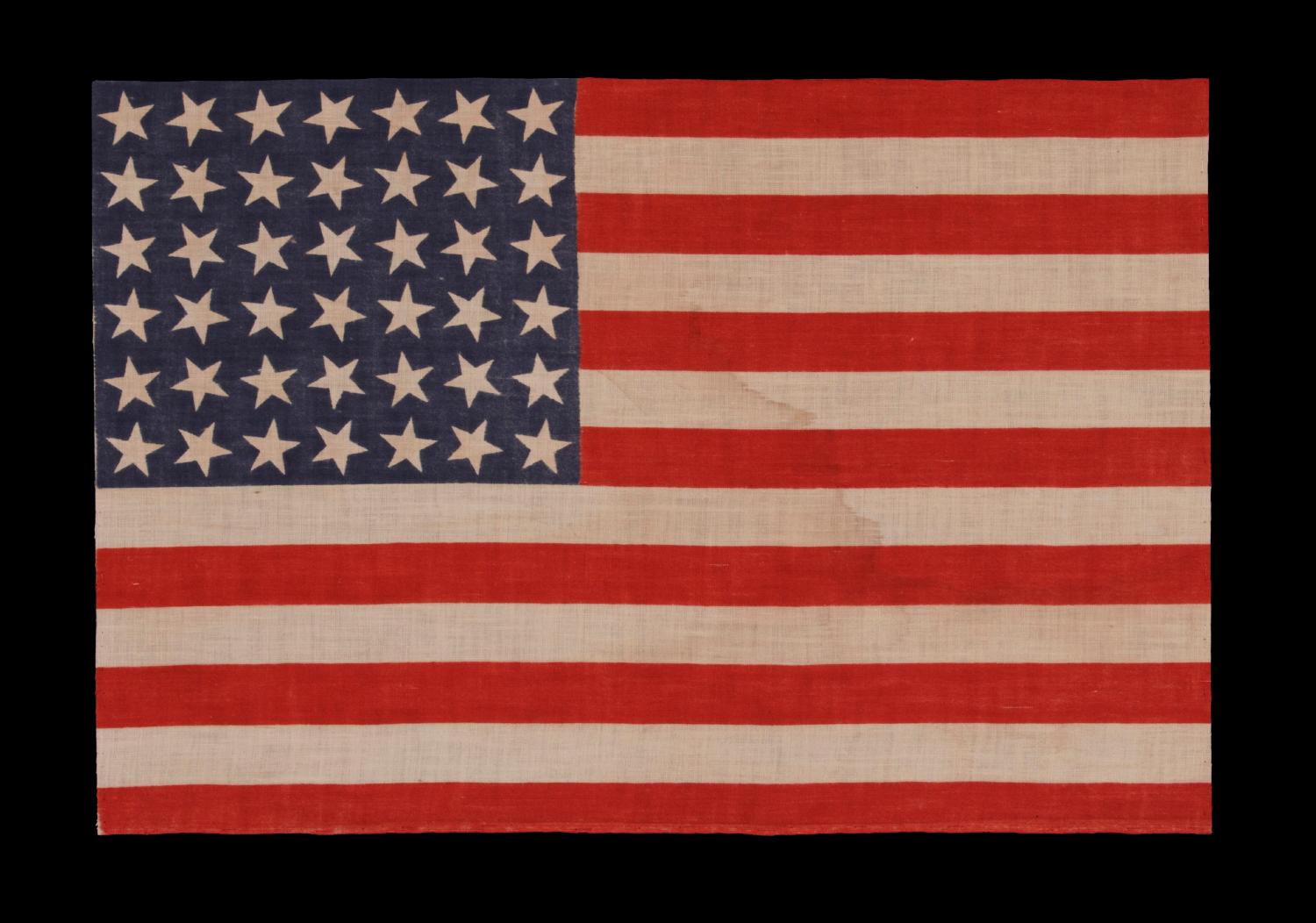 42 stars, an unofficial star count, on an antique American flag with scattered star positioning, 1889-1890, Washington Statehood:

42 star parade flag, printed on cotton muslin. The stars are arranged in a rectilinear fashion, but vary in position