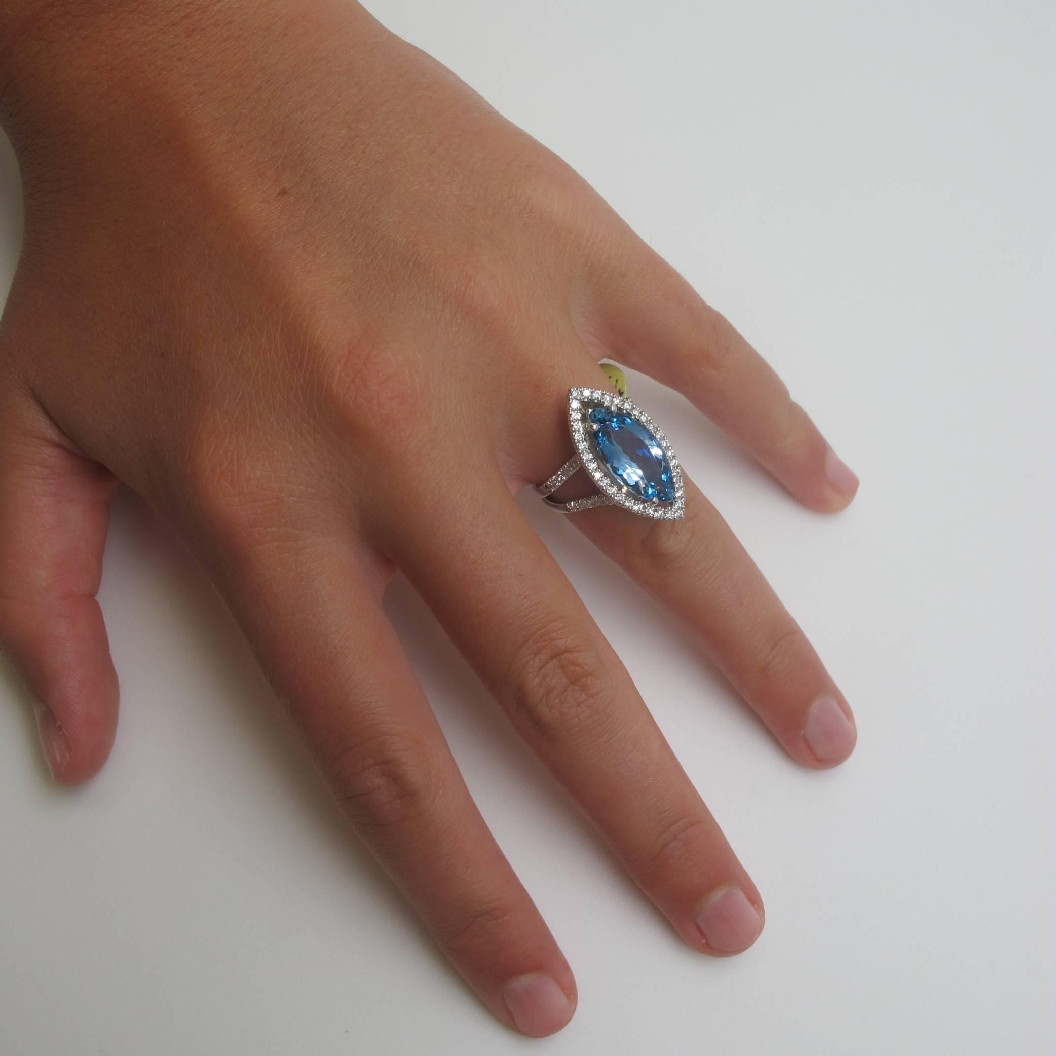 A natural, deep aqua-blue color Aquamarine (18.0x8.50mm/4.20 carats) of the finest quality is featured in this ring. Such a deep color of Aquamarine is quite rare. It is set in a custom-made 18k white gold setting with round brilliant cut White