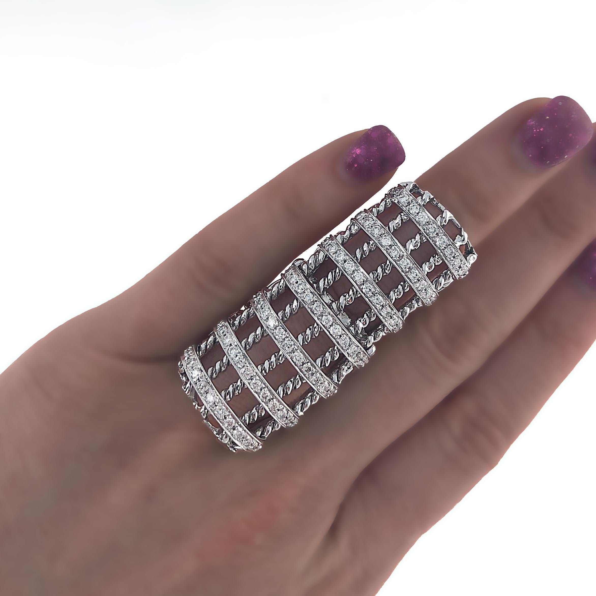 Unique 14 karat white gold diamond, cage like style, full finger ring. The ring bends at the knuckle making it easy and very comfortable to wear. There is exquisite detail on the gold. The ring is made with white round brilliant diamonds with an
