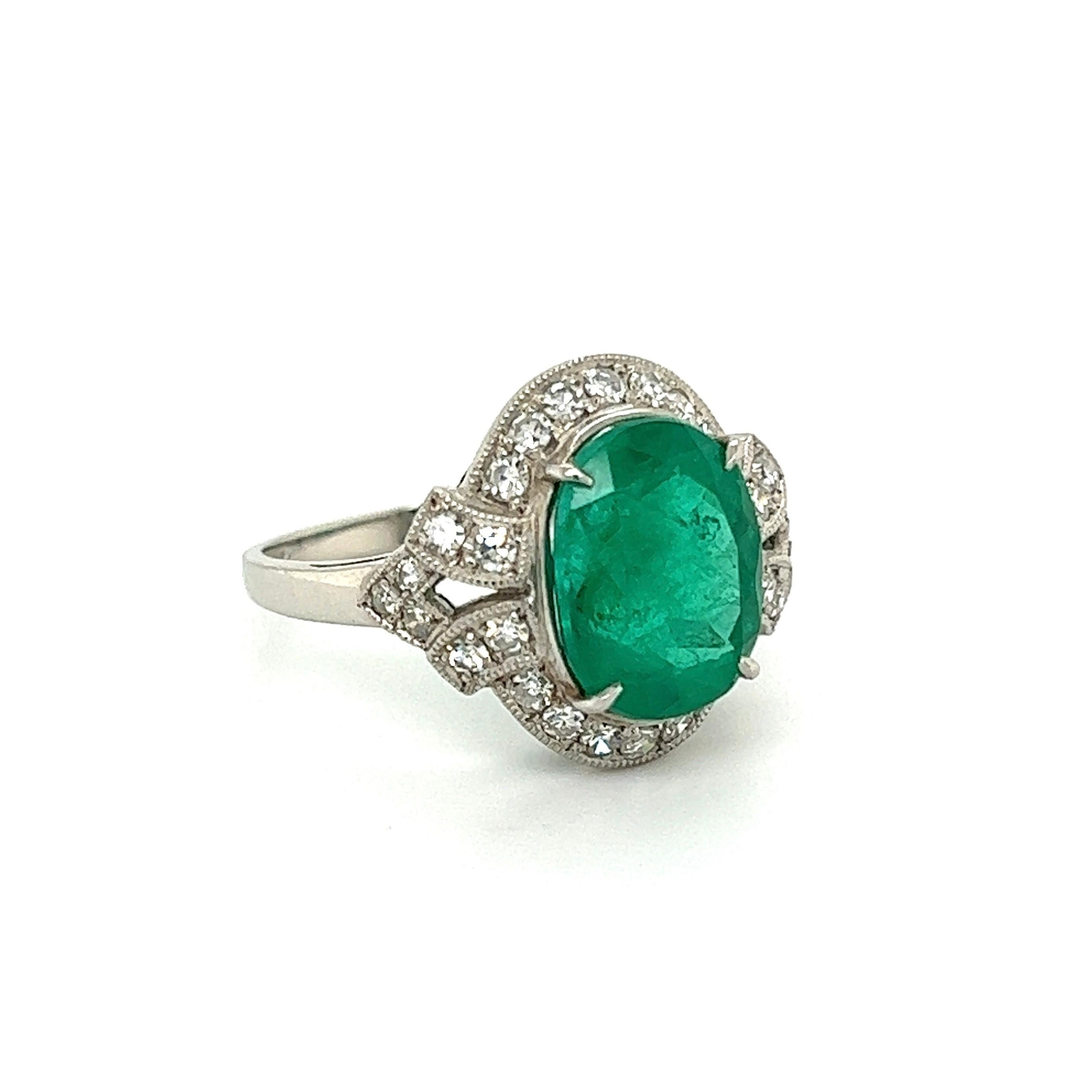 Simply Beautiful! Art Deco Revival Emerald and Diamond Platinum Ring. Centering a securely nestled Hand set 4.20 Carat Oval Emerald, surrounded by Diamonds approx. 0.61tcw. Artistically Hand-crafted Platinum mounting. Ring size 6.75, we offer ring