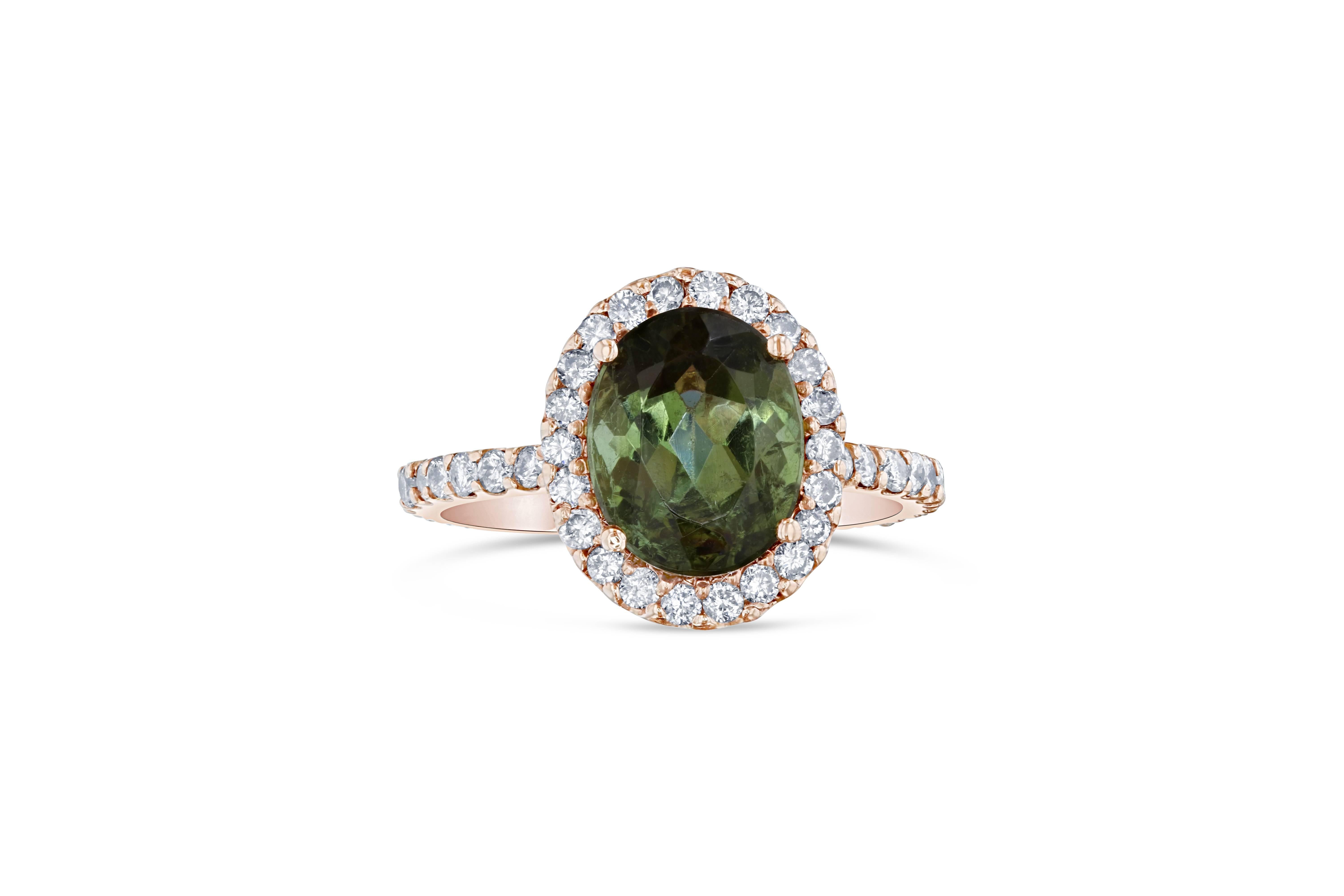 This gorgeous ring has a beautiful Oval cut Green Tourmaline weighing 3.39 Carats and 46 Round Cut Diamonds weighing 0.81 Carats. The total carat weight of the ring is 4.20 Carats. It is set in 14K Rose Gold and is a size 7 1/4. 
Ring sizing can be