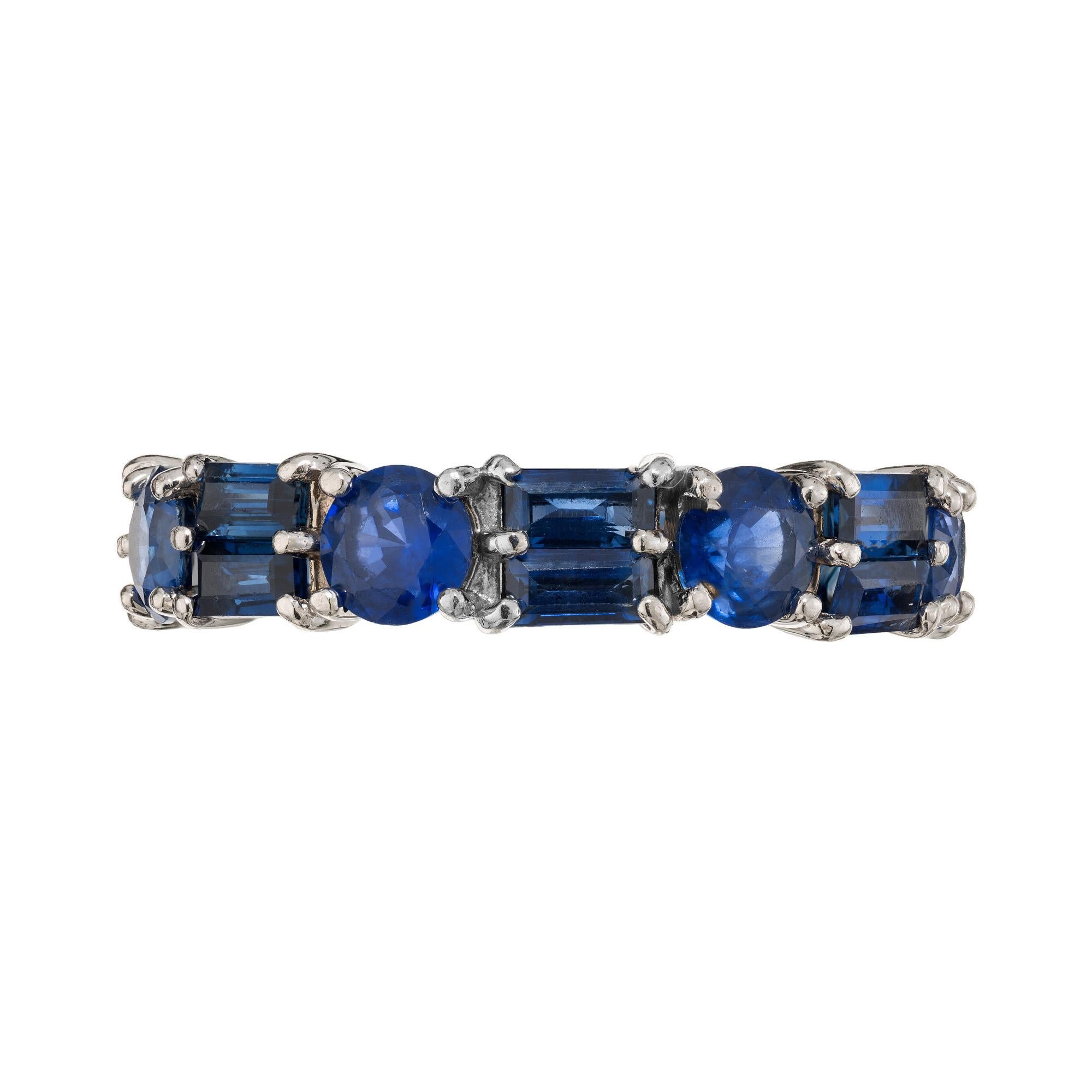 Round Baguette Sapphire Platinum Eternity Wedding Band Ring. 7 round blue sapphires totaling 2.10cts, alternating with 14 double row baguette sapphires also totaling 2.10cts. Set in platinum. This ring is a size 6.75 and not sizable. 

7 round blue