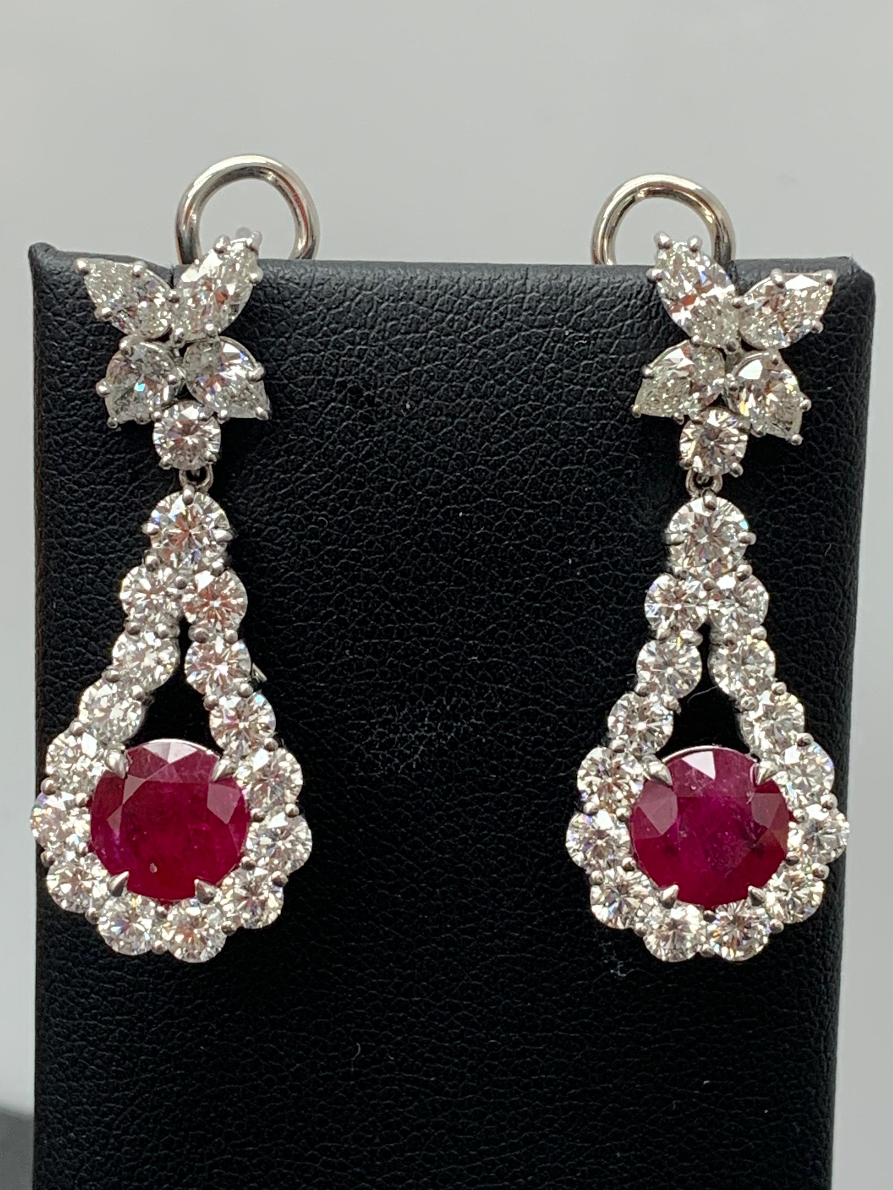 A beautiful and chic pair of drop earrings showcasing a cluster of brilliant mixed-cut diamonds, and round-cut rubies set in an intricate and stylish design. 10 Mixed cut Diamonds weigh 1.91 carats in total. 2 vivid red rubies weigh 4.20 carats in