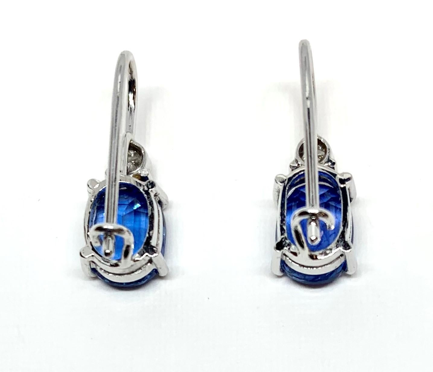 Simplicity at it's finest! These sapphire and diamond earrings are the perfect addition to any fine jewelry collection. Two cornflower blue sapphires weighing 4.20 carats total are featured in these beautiful earrings. Two round brilliant cut