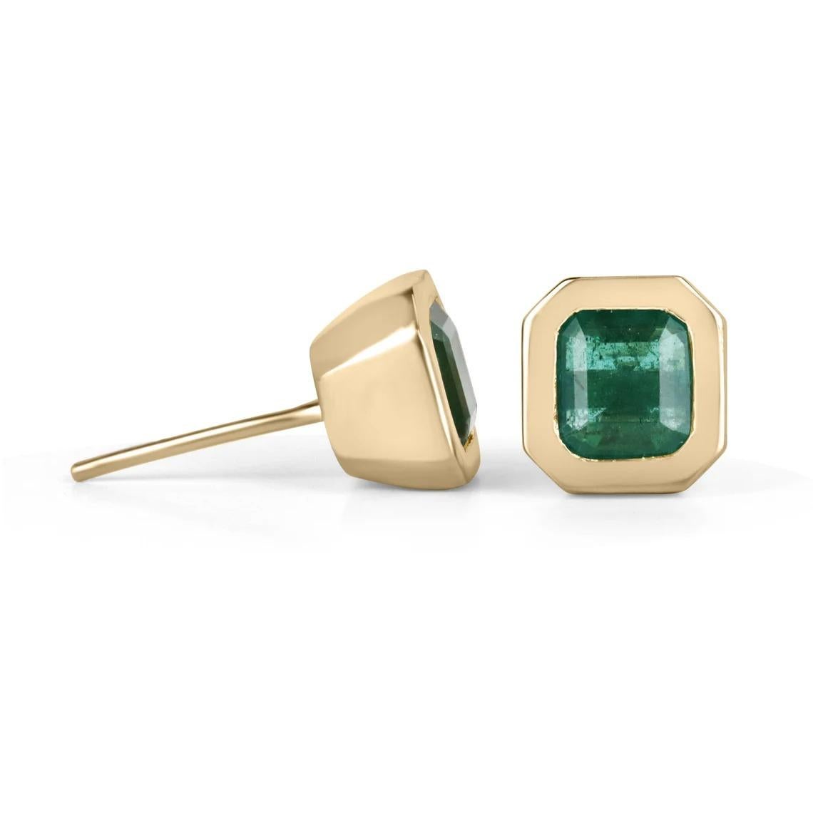 Bezel-set green emerald Asscher cut stud earrings make a stylish statement in beauty. These 14k gold stud earrings are hand-made by our expert jeweler and showcase 4.20 carats of natural emeralds, showing full earlobe coverage for an impressive