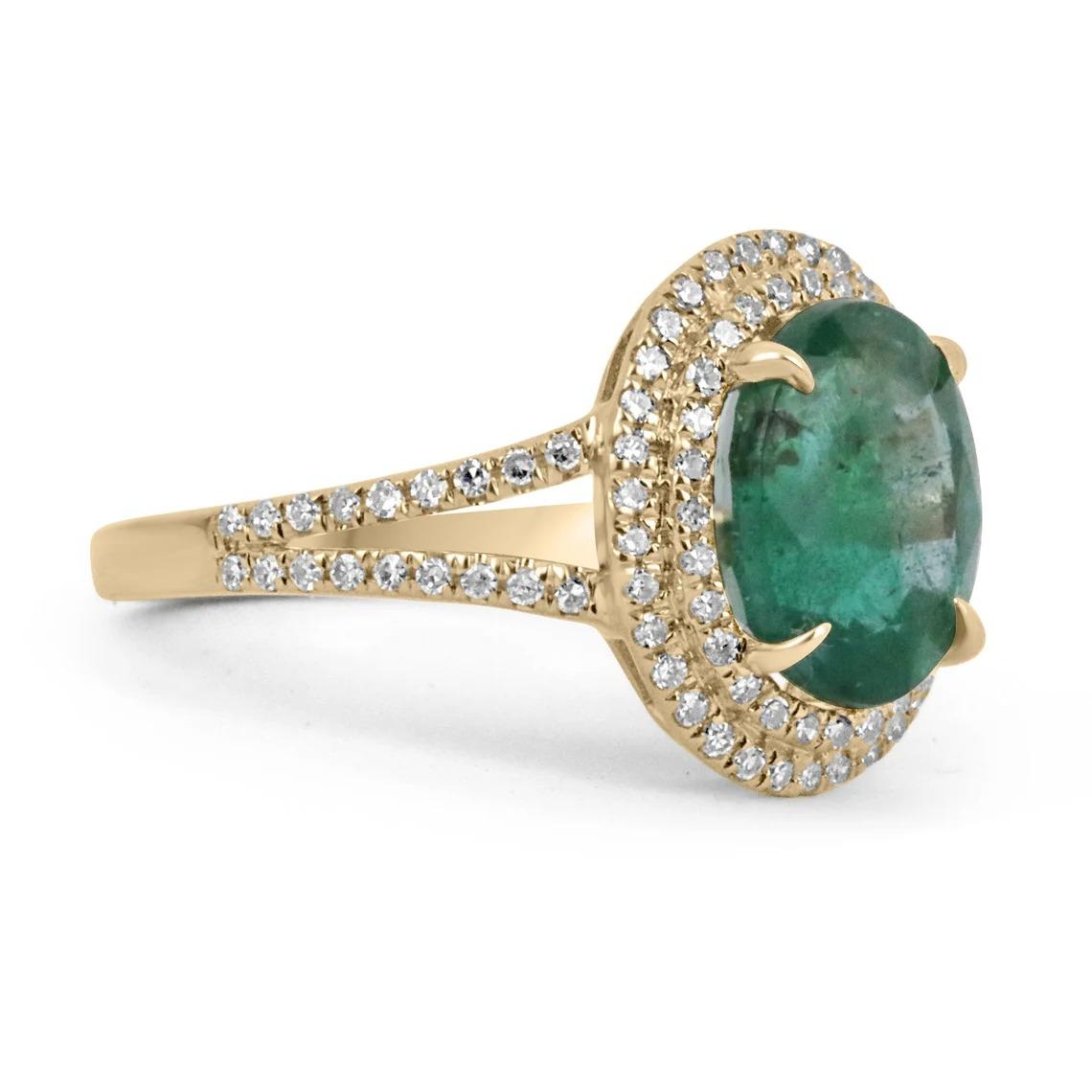 Featured is a stunning emerald and diamond ring. The center gemstone showcases a beautiful 3.80-carat, natural oval cut emerald from the origin of Zambia. Displaying a gorgeous and lush dark green color, with a yellow hue to it. Surrounding this