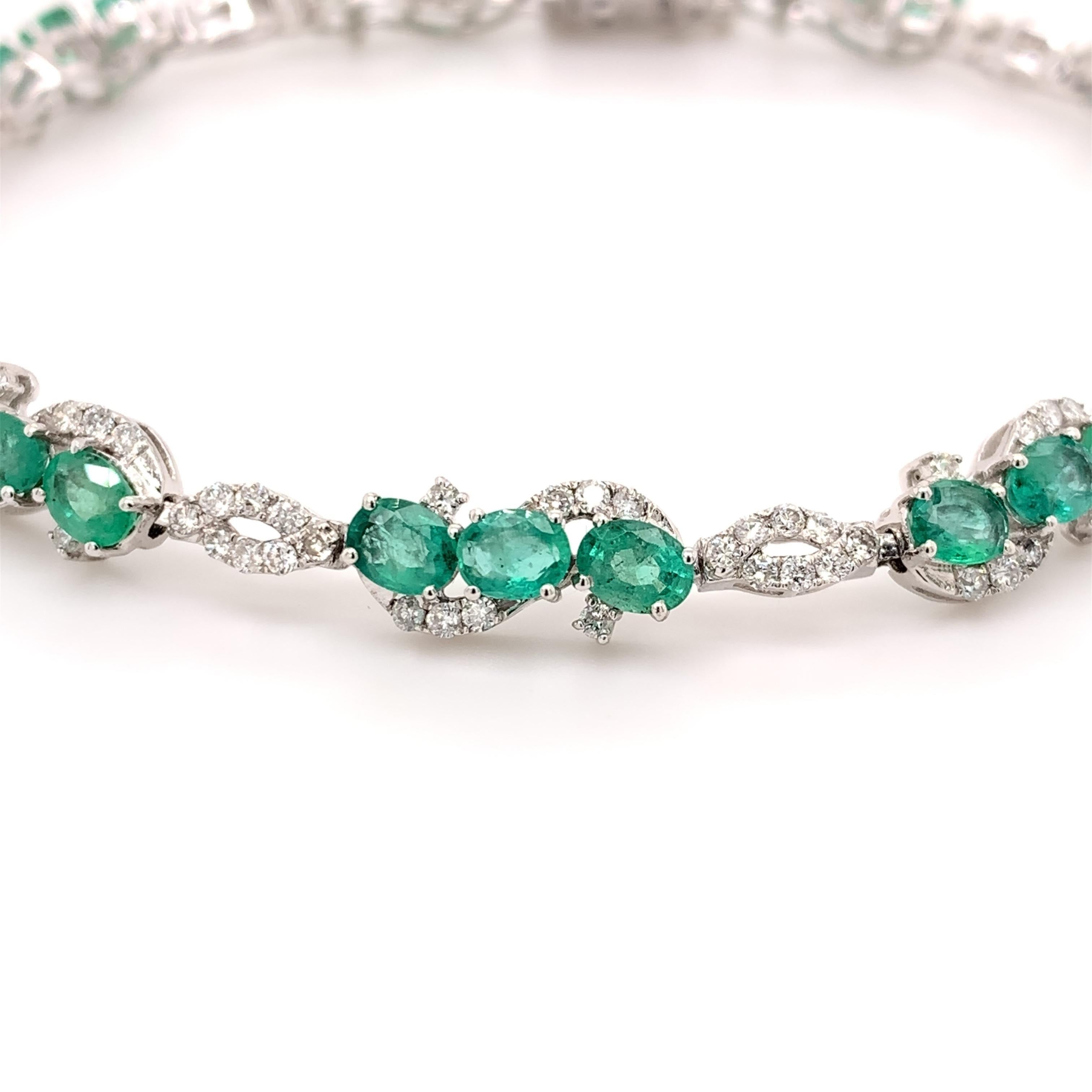 Elegant emerald diamond bracelet. Lively green with brilliance, oval faceted 4.21 carats natural emeralds mounted in an open basket with bead prongs. Accented with round brilliant cut diamonds. Handcrafted delicate design set in 14 karats white gold