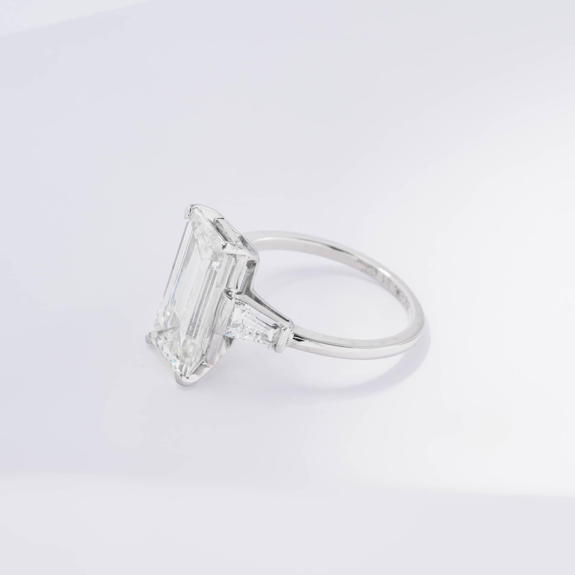 Platinum ring featuring one Emerald cut diamond weighing 4.21 carats with a color and clarity of K VS1 respectively, measuring 13.77 x 7.35 x 4.42mm; accompanied with GIA certificate #6204070942 set in a 4 prong basket style with 2 tapered diamond