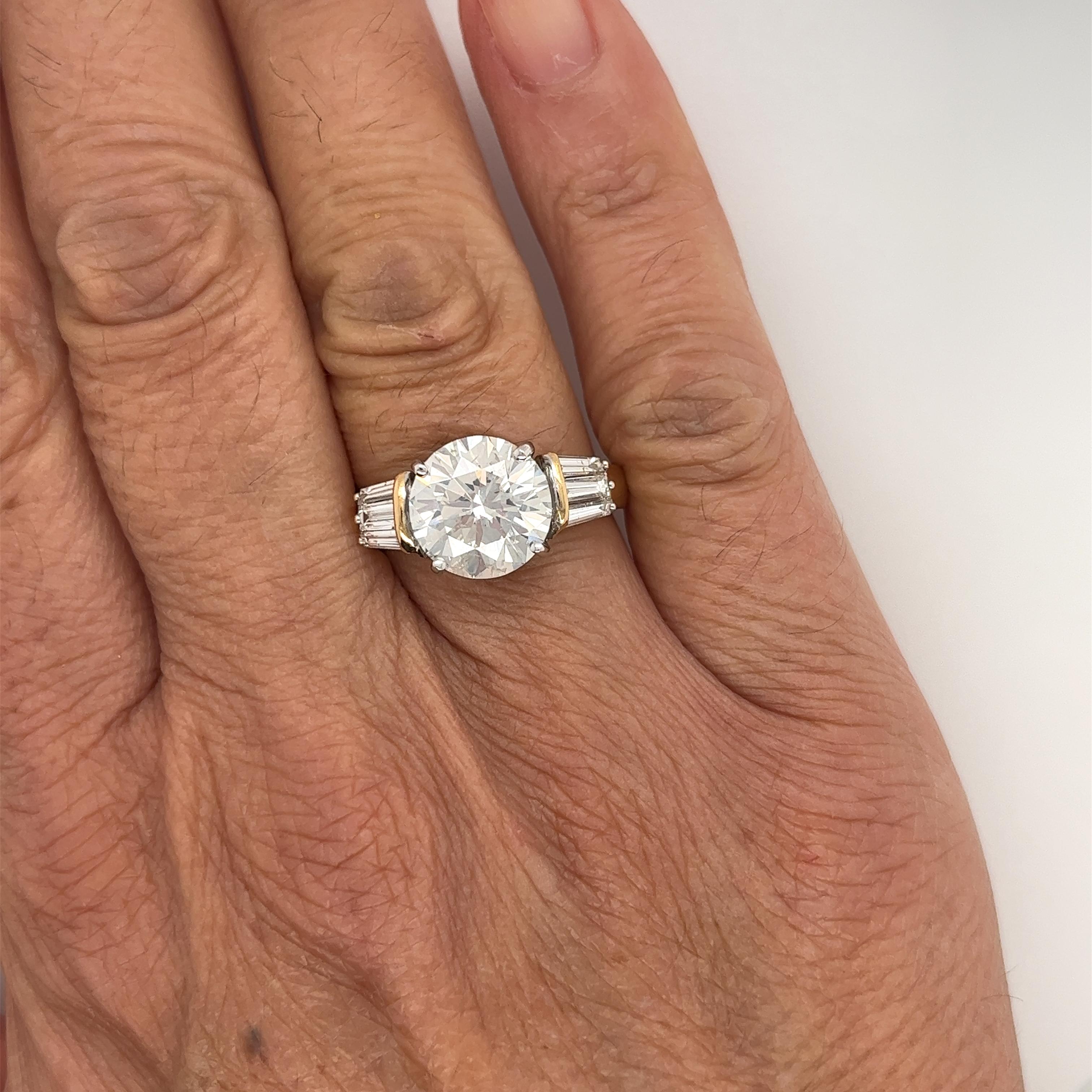 EGL certified 4.21 carat round cut natural diamond engagement ring. Set in a gorgeous two-tone 18k gold mounting. The center stone is adorned with 6 baguette-cut diamond side stones.

The center stone is a true bargain gem due to its details on