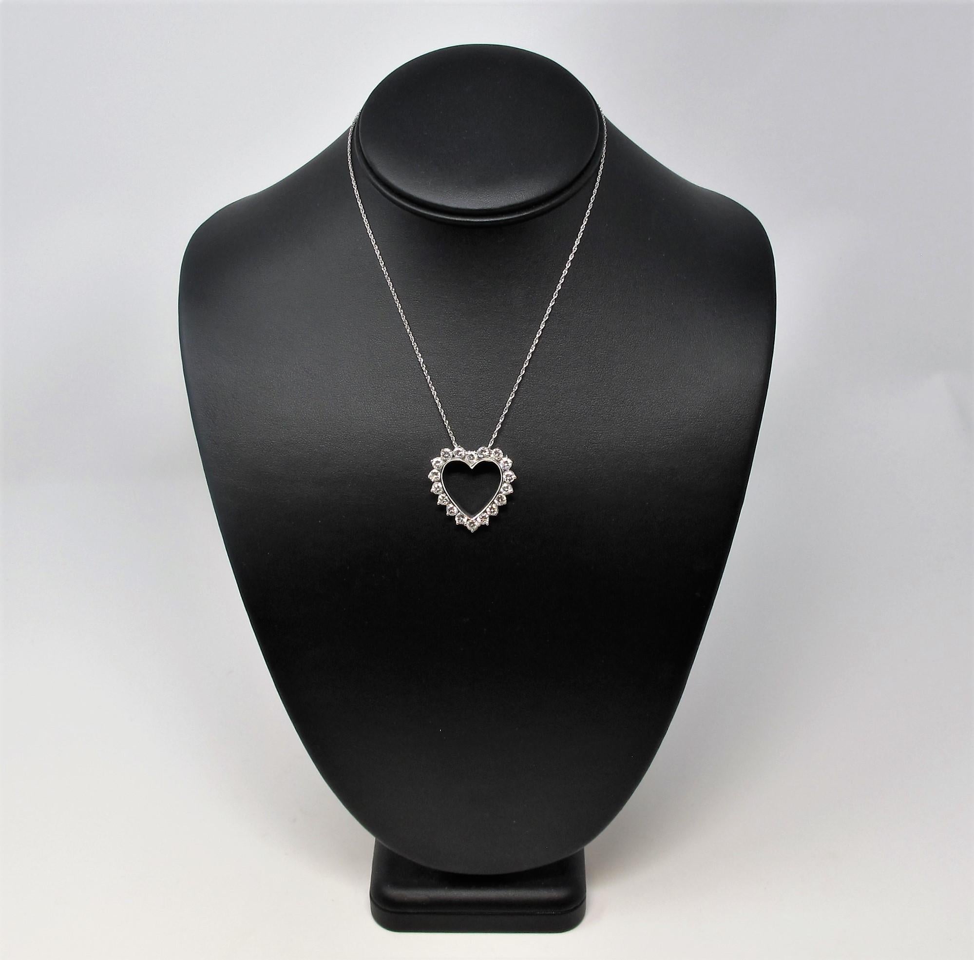 You will fall head over heels in love with this breathtaking open heart pendant necklace. The sizable round diamonds are a bright, icy white and sparkle beautifully from all angles.  This timeless piece can also be worn as a brooch, making it the