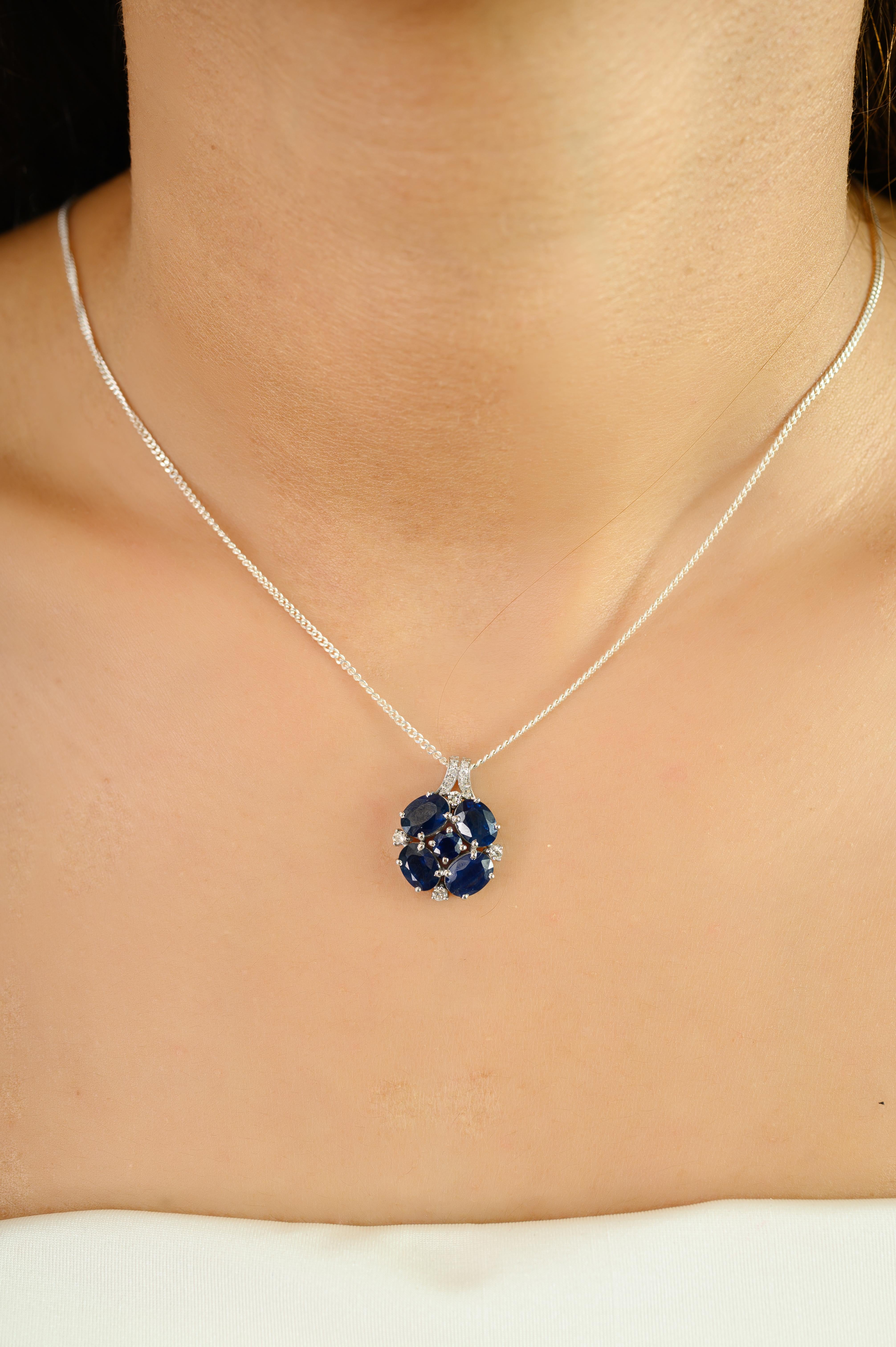 Elevate your elegance with this exquisite pendant crafted in 14k white gold, featuring a captivating cluster of deep blue sapphires totaling 4.21 carats. Arranged in a harmonious floral-inspired design, the richly hued sapphires are beautifully