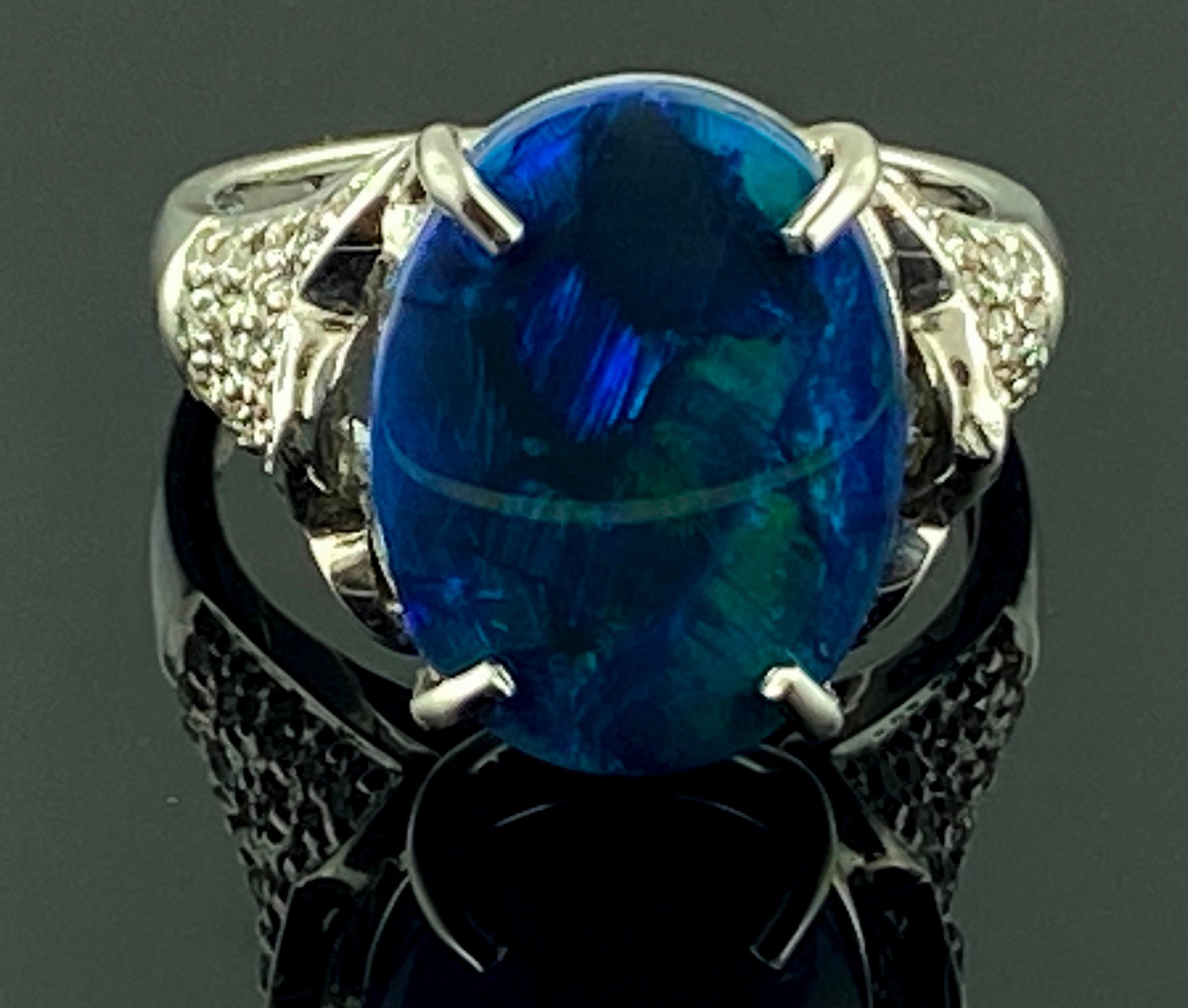 Set in 14 karat white gold is a 4.22 carat oval shaped Black Opal in the center.  The mounting has 42 round brilliant cut diamonds with a total diamond weight of 0.40 carats.  Gold weight is 6.6 grams.  Ring size is 7.5