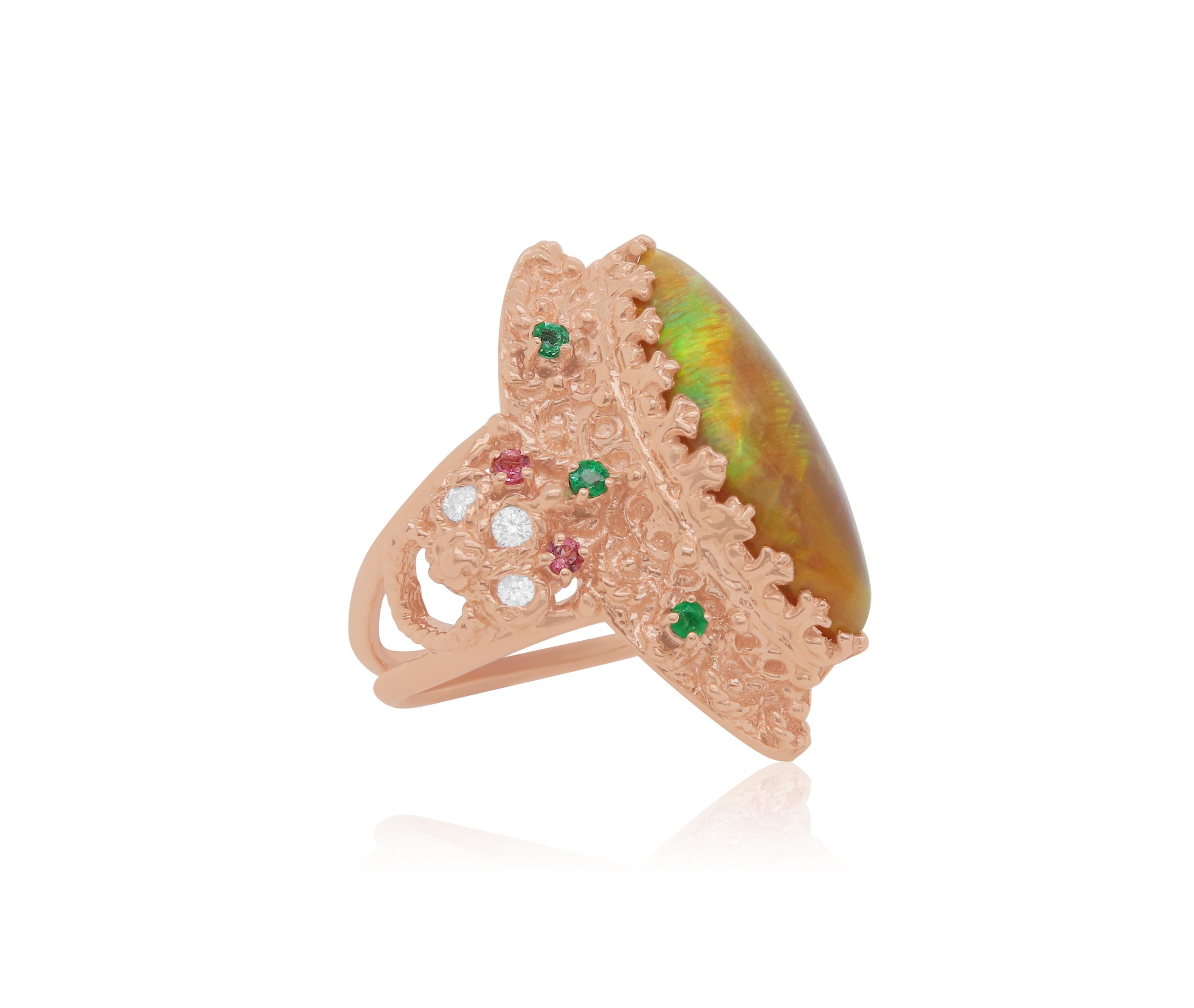 Material: 14k Rose Gold 
Center Stone Detail:  1 Marquise Opal at 4.22 Carats - Measuring 22.4 x 9 mm
Mounting Stone Details:  4 Round Pink Tourmalines at 0.12 Carats
Stone Details:  6 Round Emeralds at 0.20 Carats
Diamond Details: 6 Brilliant Round