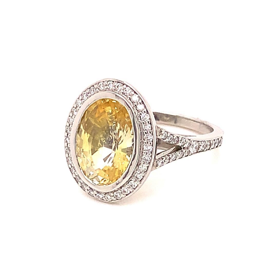 A single glance at this ring is all that is required to notice how uniquely stunning it is. Made of an Oval Brilliant Yellow Sapphire weighing 4.22 Carats, glimmering Round Brilliant Diamonds weighing 0.51 Carats and set in Platinum, this glittering
