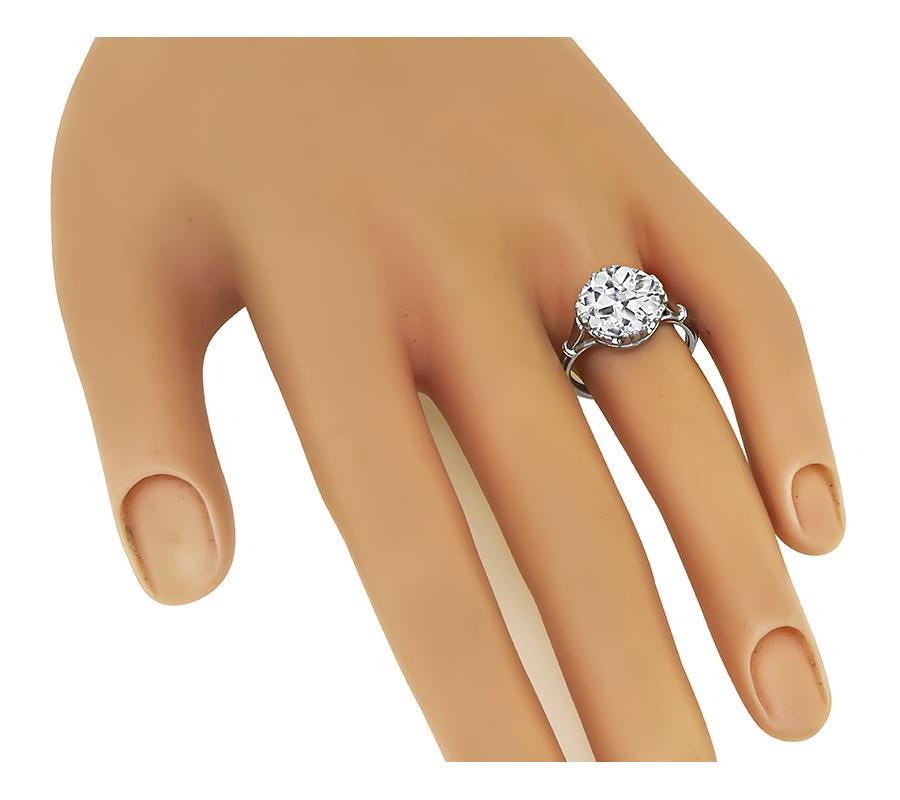 This is a stunning platinum engagement ring. The ring is set with sparkling old mine cut diamond that weigh approximately 4.22ct. The color of the diamond is M with VS clarity. The top of the ring measures 11.5mm in diameter. The ring weighs 5.5