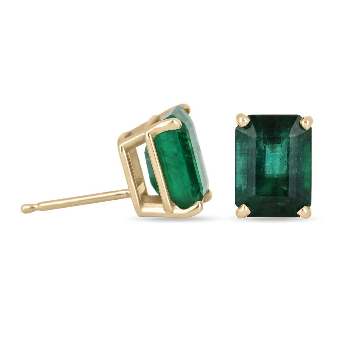 Featured here is a beautiful set of AAA VIVID dark forest green emerald cut emerald studs in solid fine 18K solid yellow gold. Displayed are very large RARE statement size dark green emeralds with very good transparency, accented by a simple