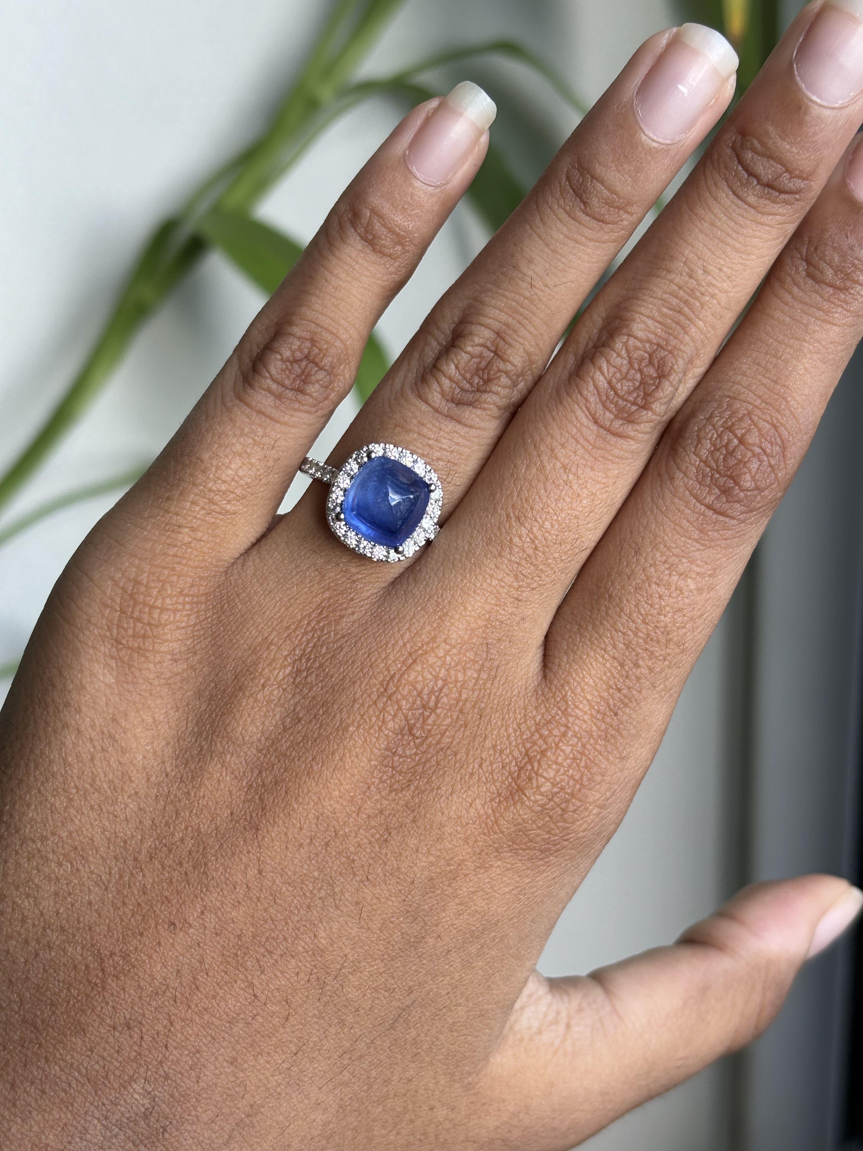 This exceptional ring showcases the allure of a rare Sugarloaf Sapphire, its distinctive shape reminiscent of a majestic mountain peak, radiating an air of regal splendor.

The centerpiece of this ring is the resplendent 4.23 Carat Sugarloaf cut