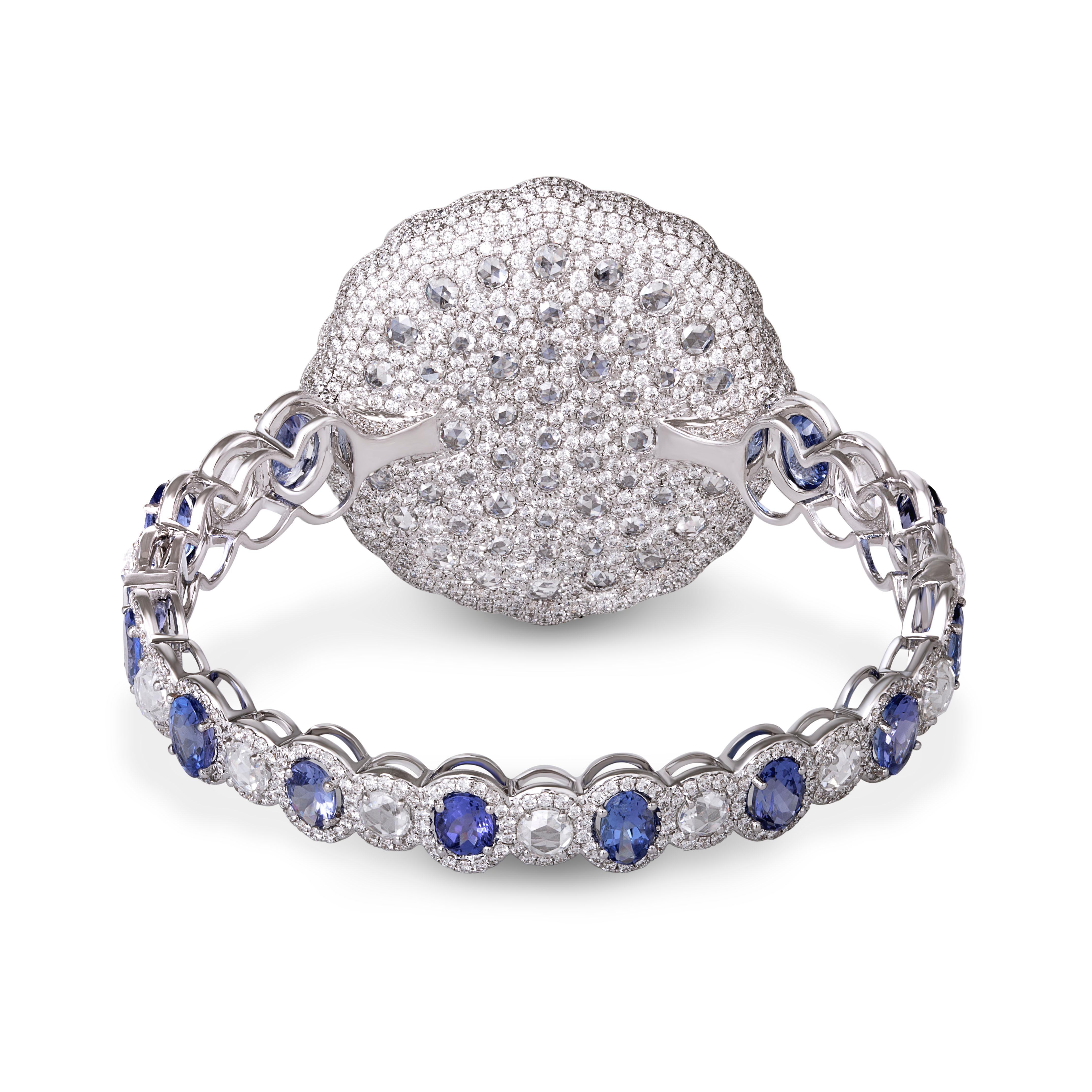 Consisting of a central deep blue-hued oval tanzanite, encased with rose-cut diamonds and a further 22 pear-shaped tanzanites, this striking bracelet combines colour, symmetry and finesse, to reinterpret the grace and beauty found in nature. 

Total