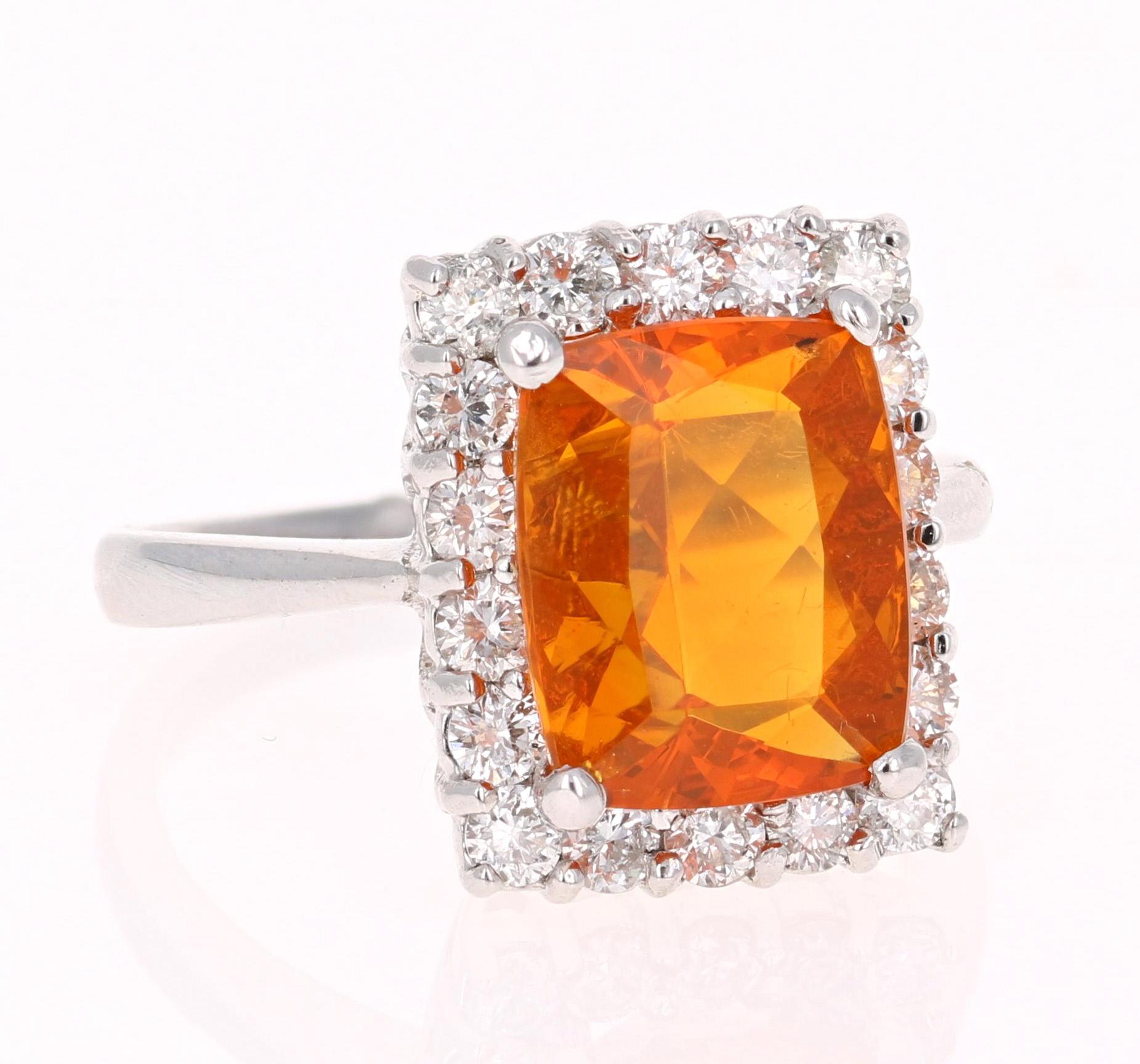 Beautiful Fire Opal and Diamond Ring. This ring has a 3.29 carat Cushion Cut Fire Opal in the center of the ring and is surrounded by a halo of 18 Round Cut Diamonds that weigh a total of 0.95 carat.  The total carat weight of the ring is 4.24