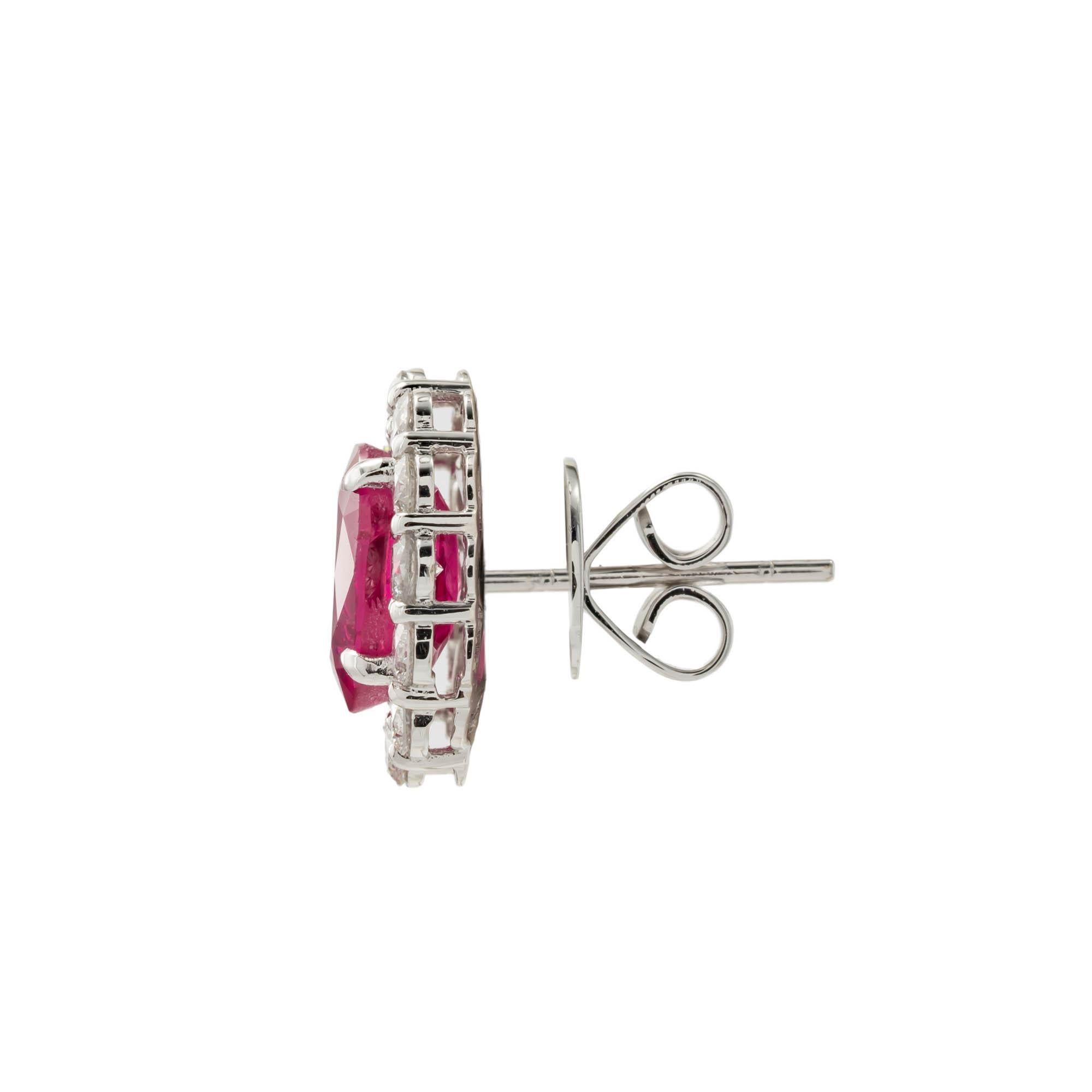 Platinum vintage style earrings featuring two oval shaped rubies having a total weight of 4.24 carats with with AGTA certificate #95000505 stating no heat the rubies are framed with halo consisting of 24 diamonds with a total weight of 1.18 carats