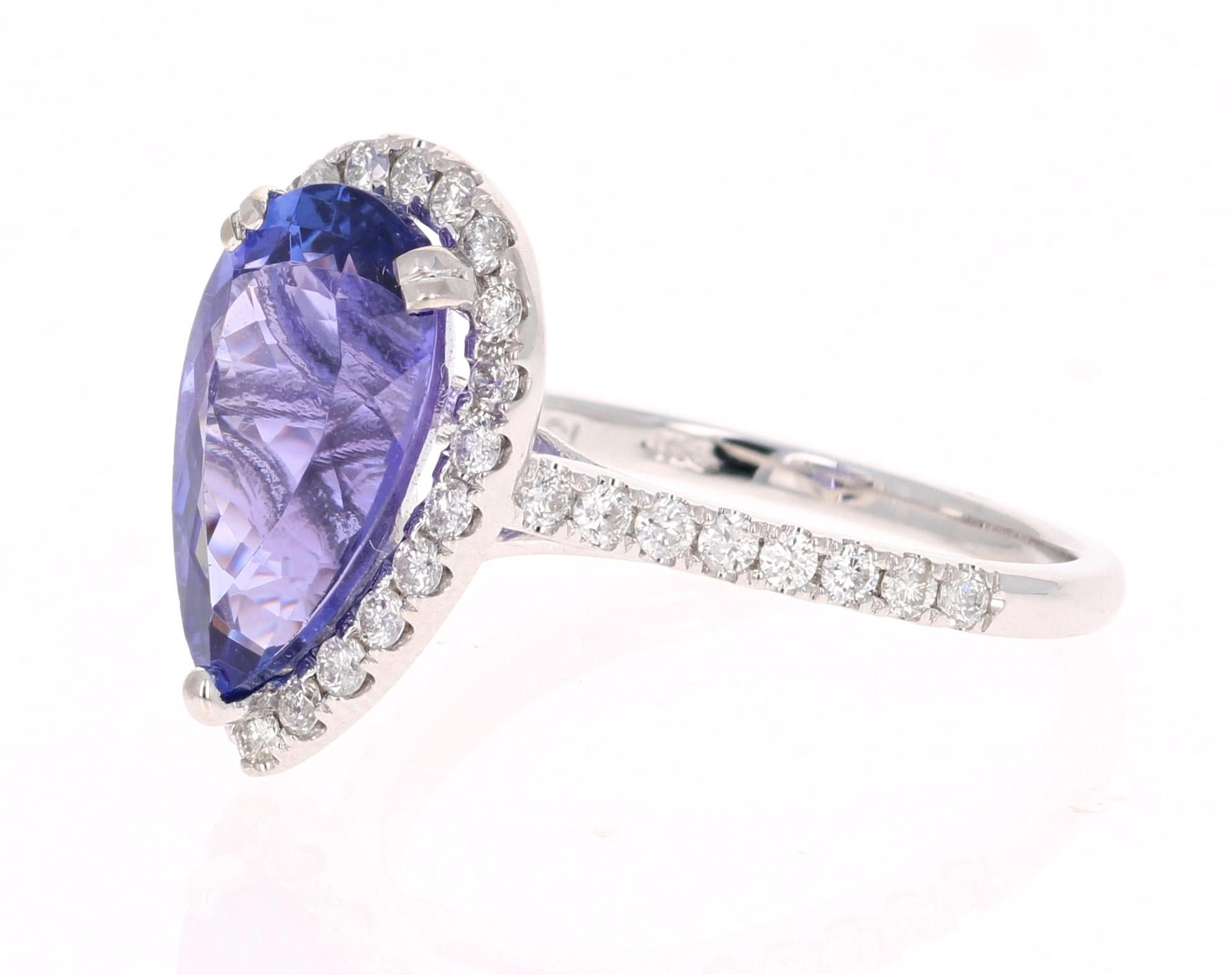 This ring has a electrifying Pear Cut bright purplish blue Tanzanite weighing 3.73 Carats. The traditional halo setting has 38 Round Cut Diamonds that weigh 0.51 carats which gently float around the Tanzanite. The total carat weight of the ring is