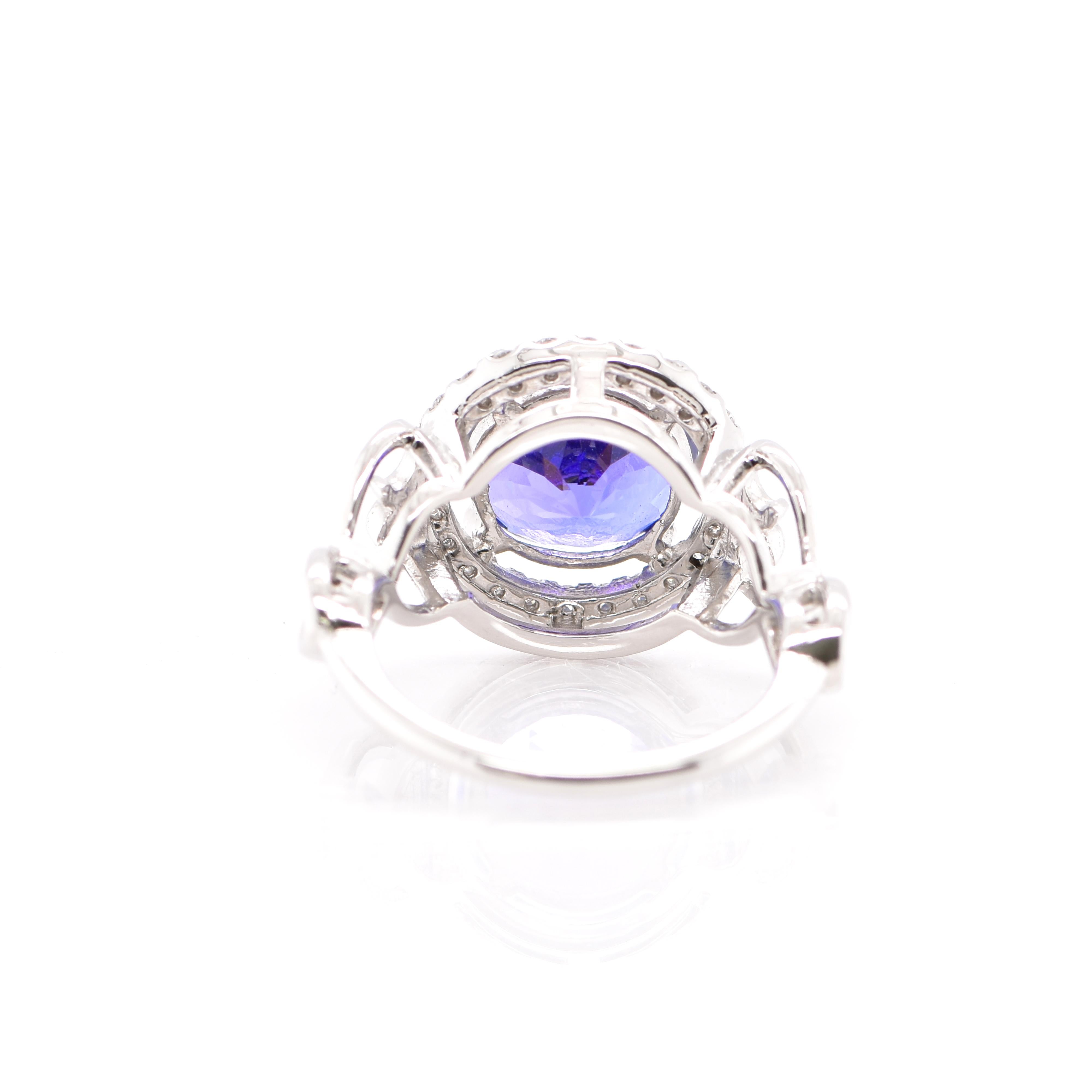 A beautiful Cocktail Ring featuring a 4.24 Carat Round Cut Tanzanite and 0.34 Carats of Diamond Accents set in Platinum. Tanzanite's name was given by Tiffany and Co after its only known source: Tanzania. Tanzanite displays beautiful pleochroic