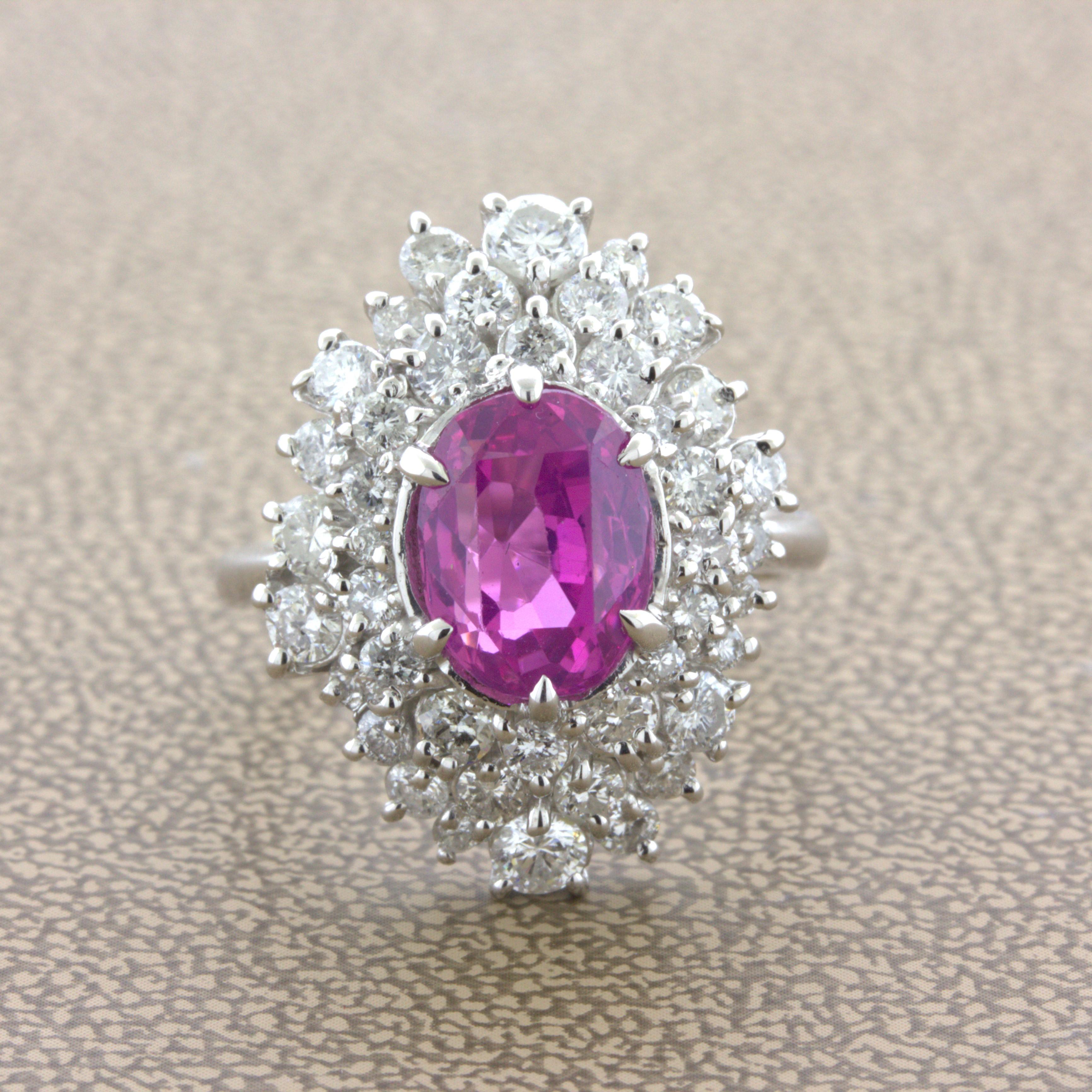 A lovely platinum ring featuring a very fine pink sapphire with a bright rich color. The 4.25 carat oval-shaped sapphire is very clean allowing the stones natural barbie-pink color to pop. It is complemented by 2.32 carats of round brilliant-cut
