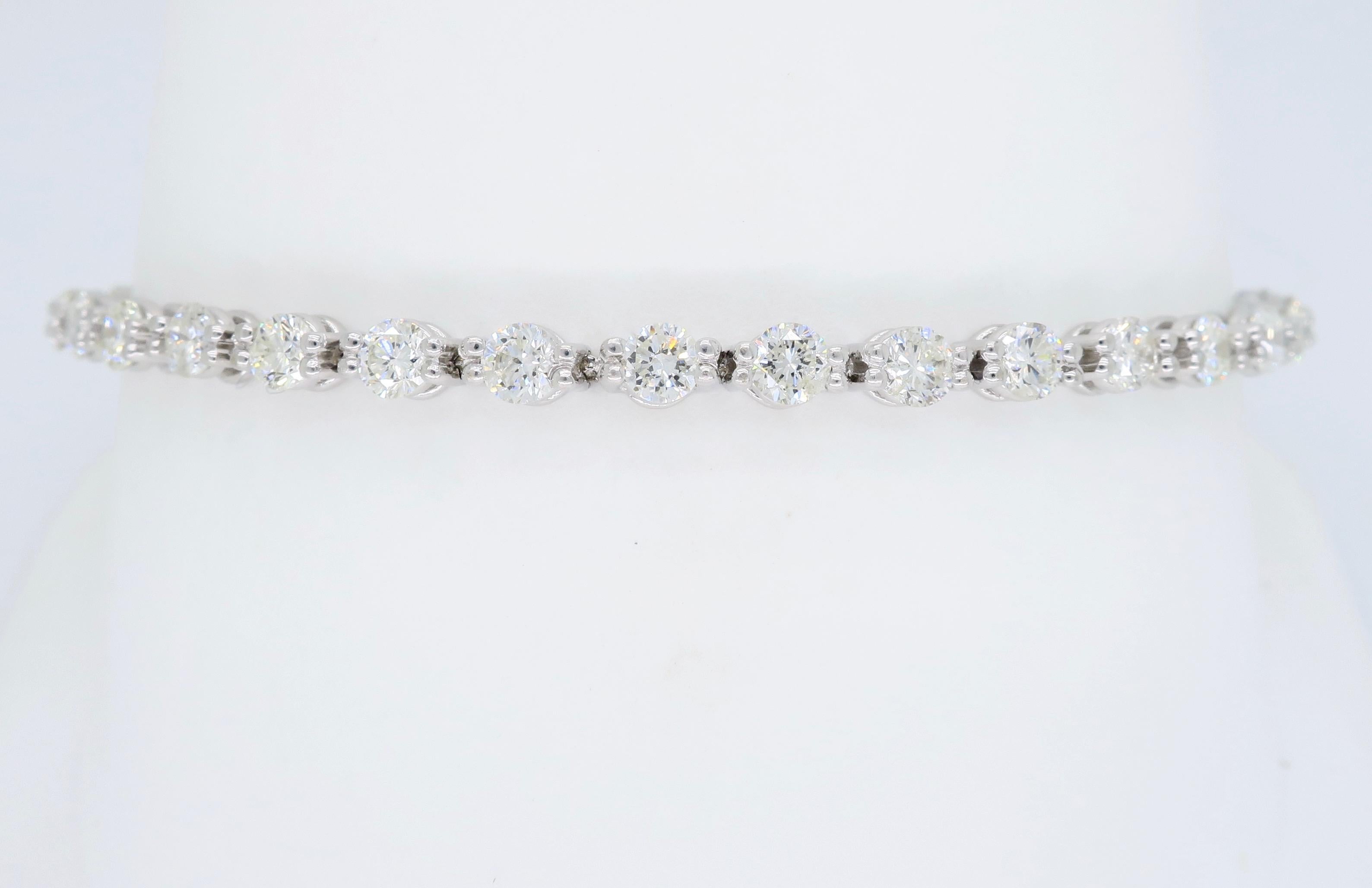 Stunning bracelet features 34 Round Brilliant Cut Diamonds with an average color of F-G and an average clarity of VS with a few SI diamonds. There is approximately 4.25CTW of diamonds in this beautiful bracelet. The 18K white gold bracelet is 7” in
