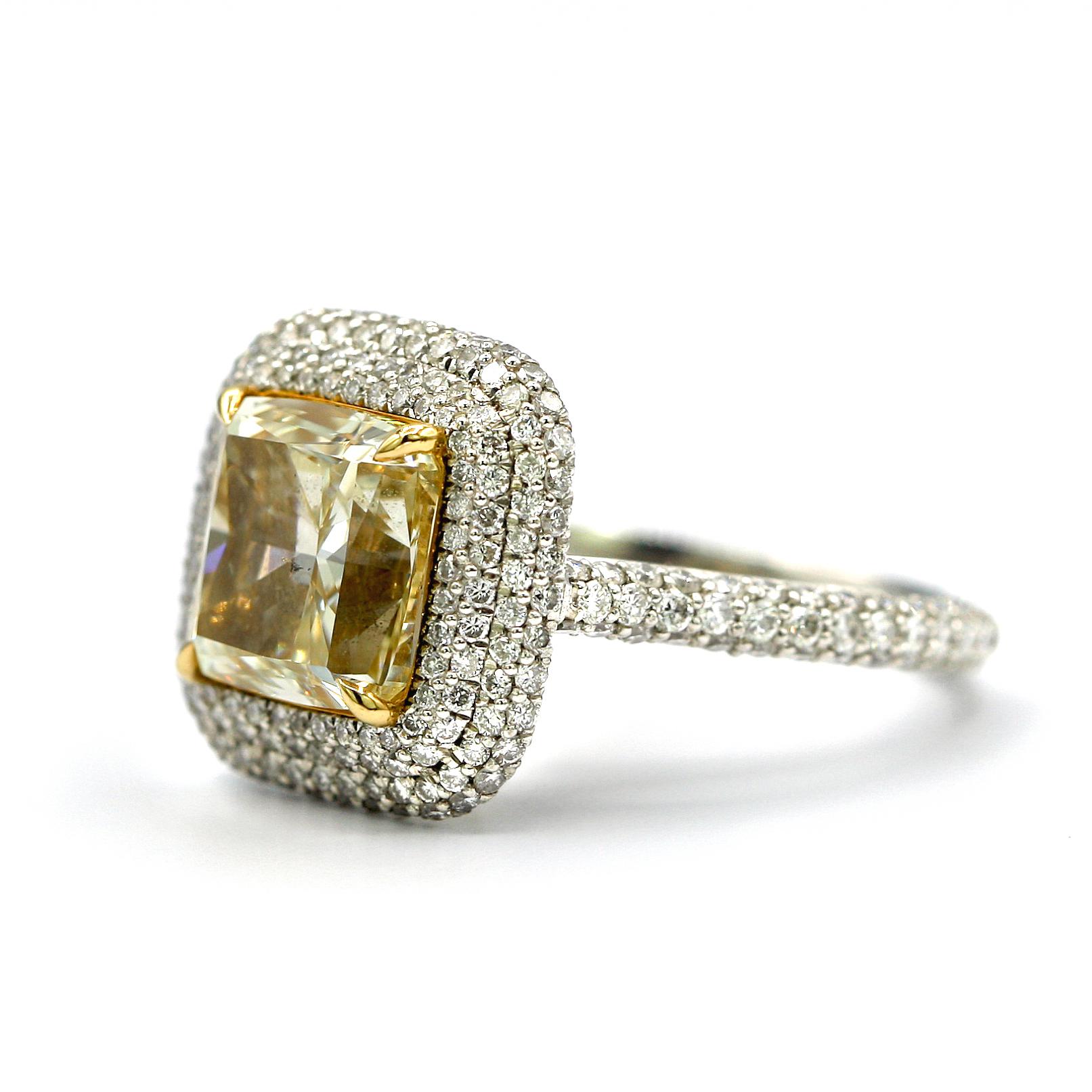 This absolutely stunning 4.25 Carat EGL Certified Fancy Light Yellow Cushion SI1 with 1.35 Carat White Pave Diamonds all around the center stone.
Ring Size 6.5
Mounted in Platinum and 18K White Gold.
