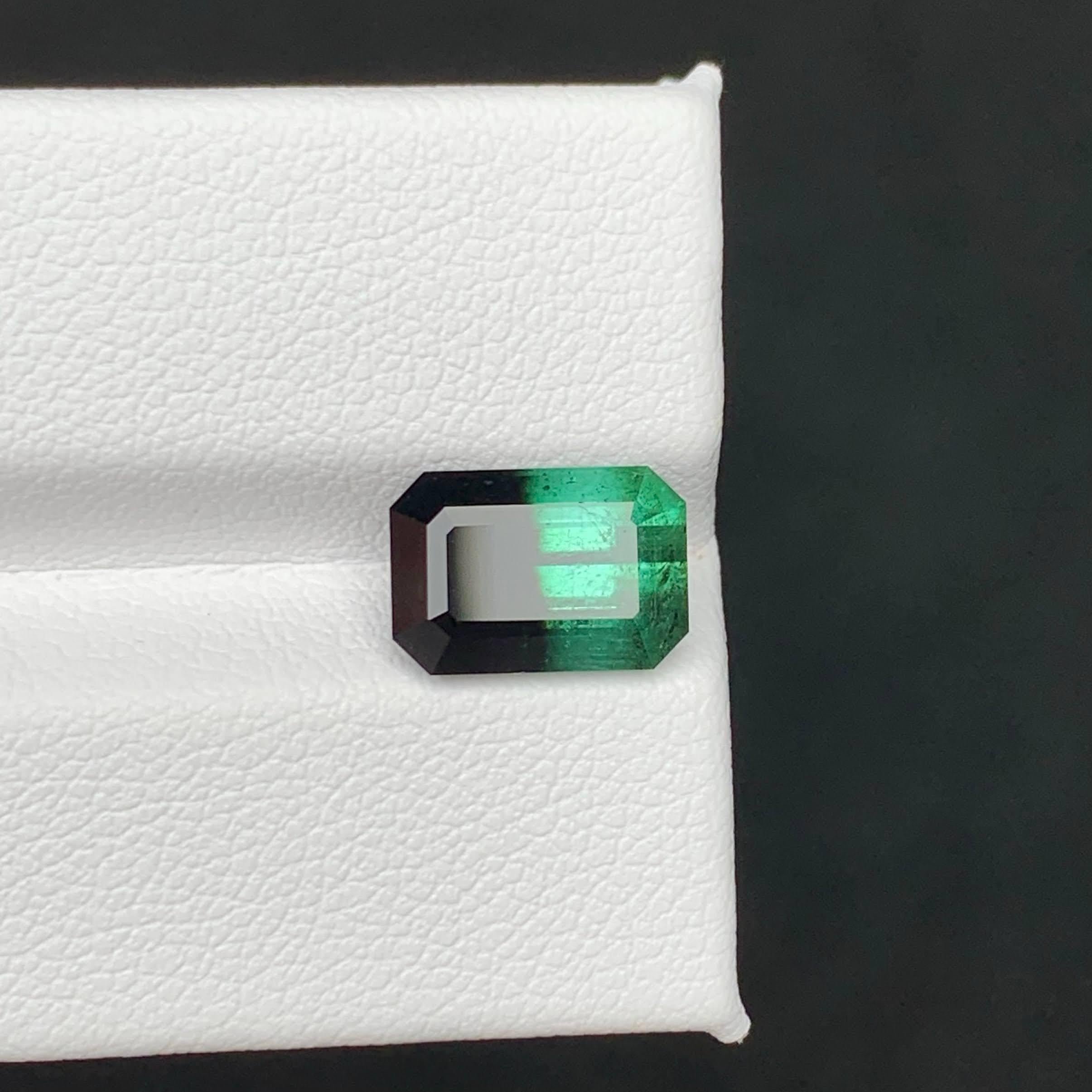 Weight 4.25 carat 
Dimensions 10.5x7.2x6.2mm
Treatment None 
Origin Pakistan 
Clarity SI
Shape Cut Emerald 




This unique 4.25-carat natural bicolor tourmaline is a rare treasure, showcasing a striking fusion of contrasting hues within a single
