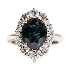 4.25 Carat Oval Teal Colour Sapphire and 1.16 Carat Diamond Halo Platinum Ring
