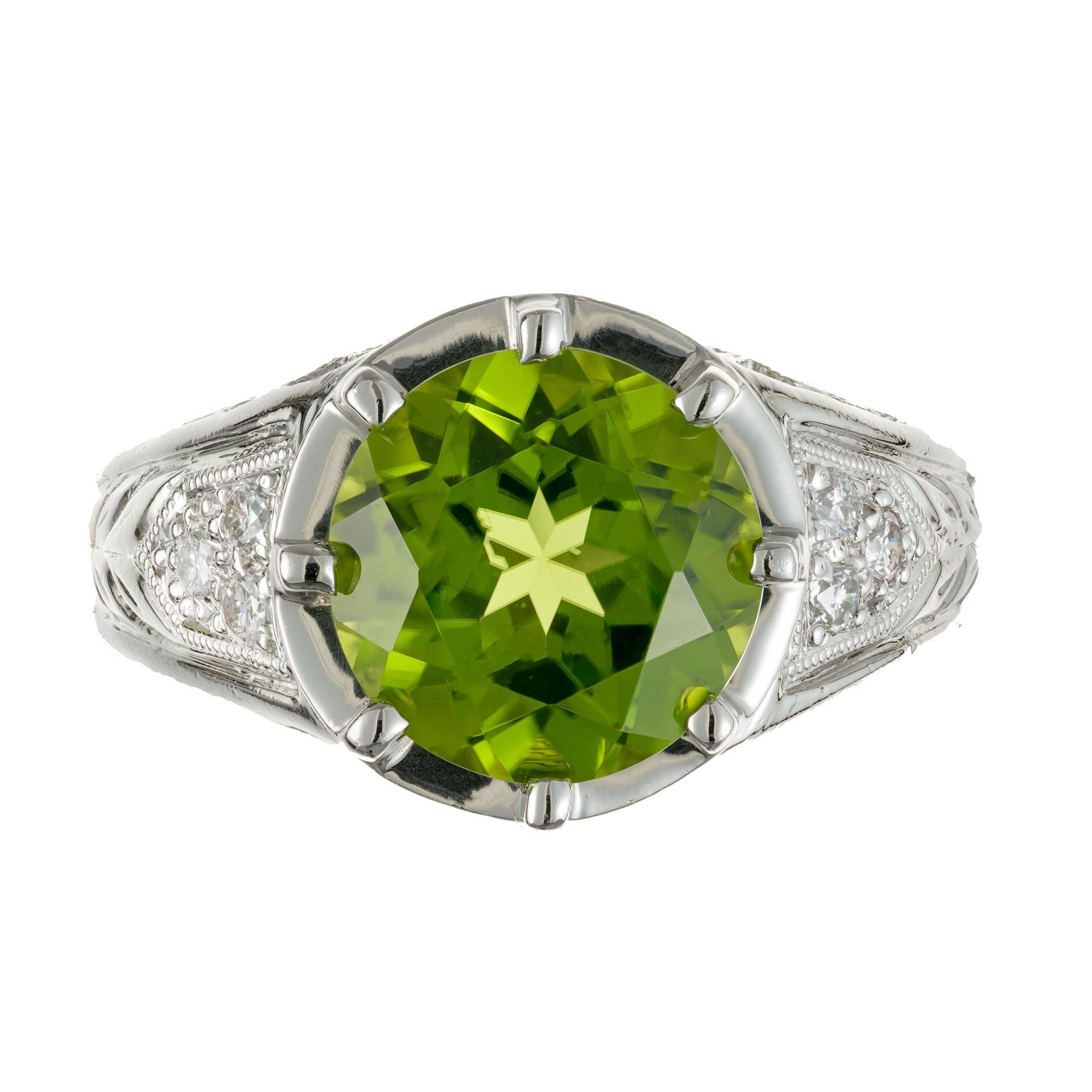 Peridot and diamond ring. 4.25ct European cut peridot center stone in a platinum setting with 14 round accent diamonds. circa 1940's.

1 round bright green gem Peridot, approx. total weight 4.25cts, VS, 10mm
14 round diamonds, approx. total weight