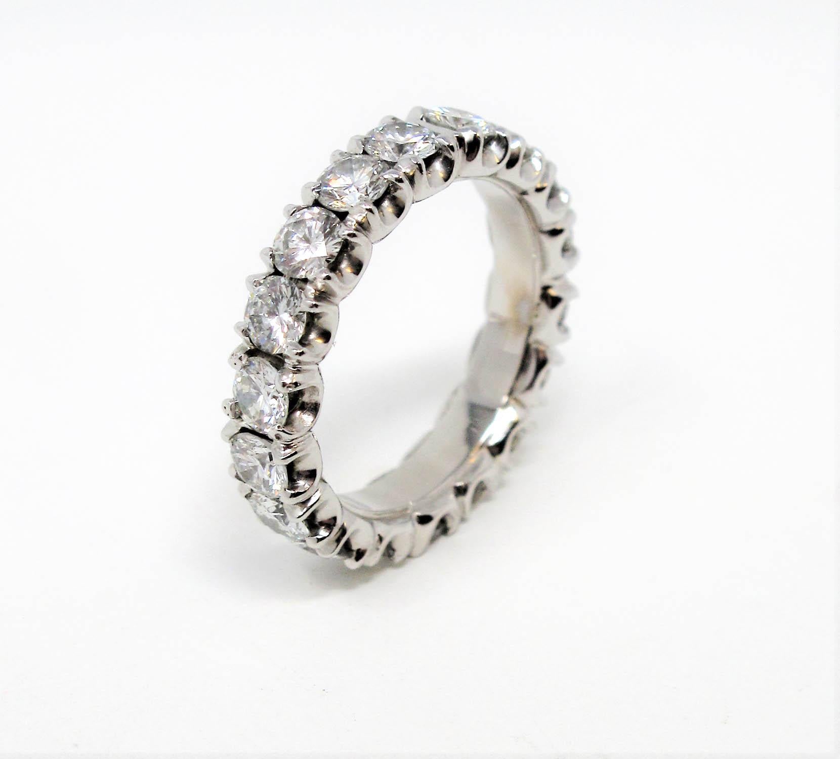 Absolutely gorgeous diamond eternity band ring. This remarkable ring features a full circle of icy white round diamonds that truly shimmer and shine from every angle. The slightly wider band style also enhances the incredible sparkle, making this