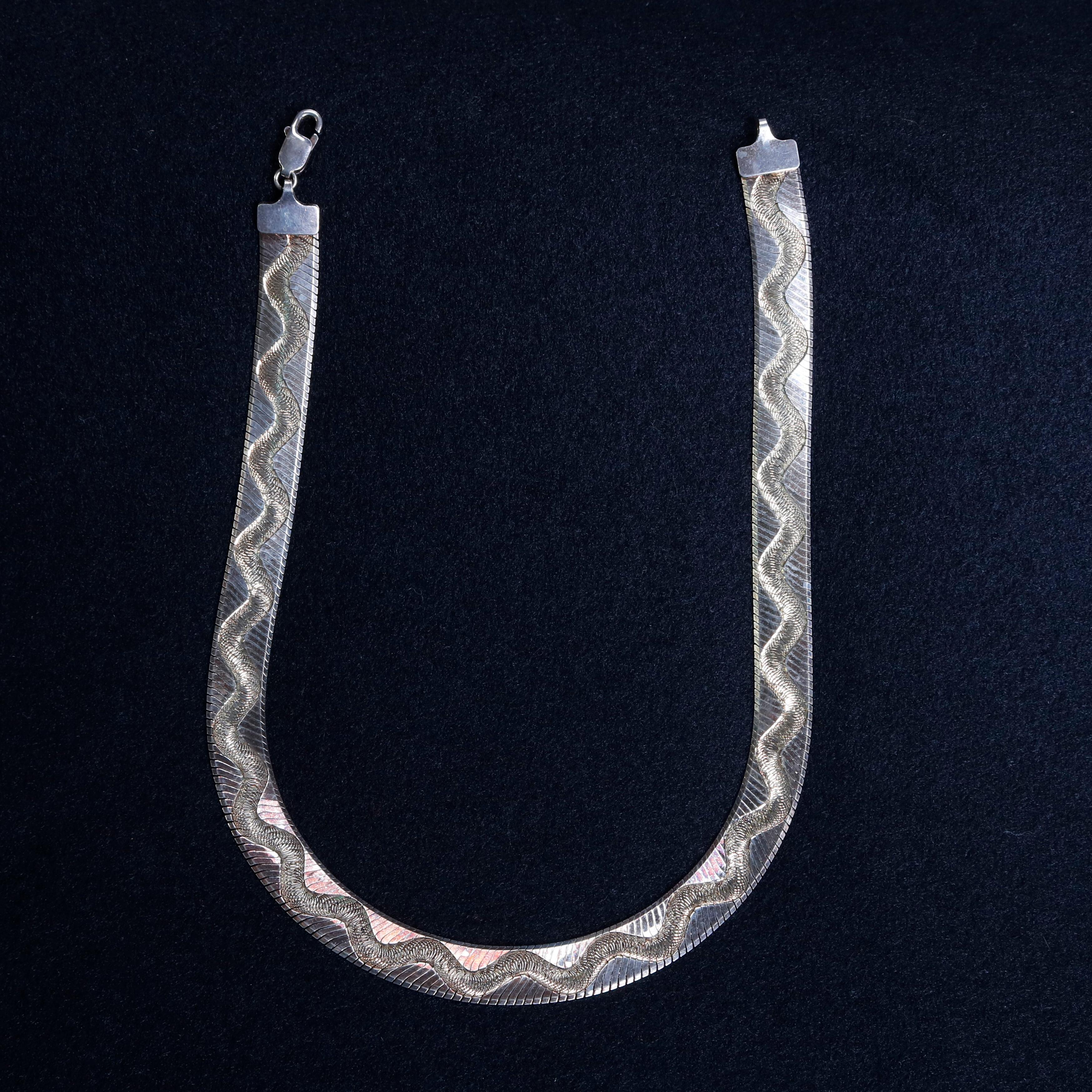 A sterling silver herringbone link necklace offers engraved zig-zag snake patterning, 17