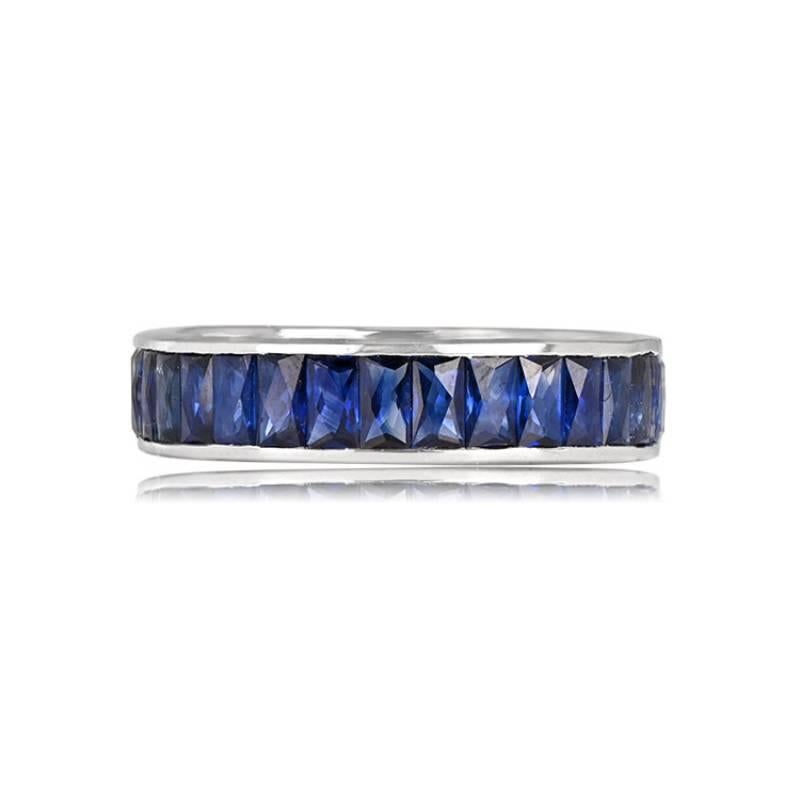 A captivating platinum eternity band featuring a channel set of 4.25 carats of elongated French cut sapphires arranged in a north-south orientation. The band boasts a stylish width of 4.60mm, showcasing the perfect blend of precious metal and
