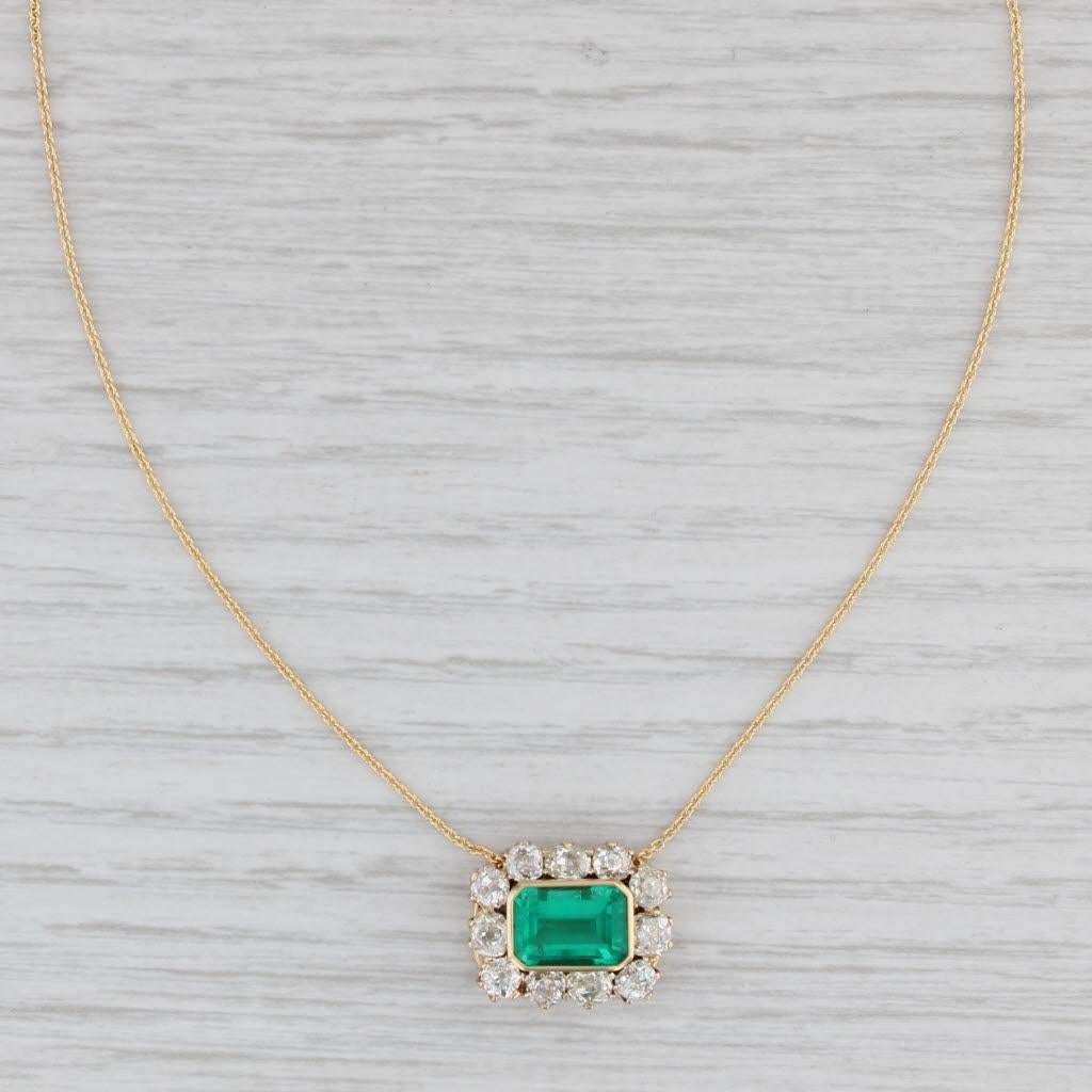 This gorgeous necklace has an antique pendant set with a brilliant green emerald framed by a halo of sparkling diamonds. The eye catching pendant sits on a new cable chain necklace compose of solid 18k yellow gold. The chain secures with an easy to