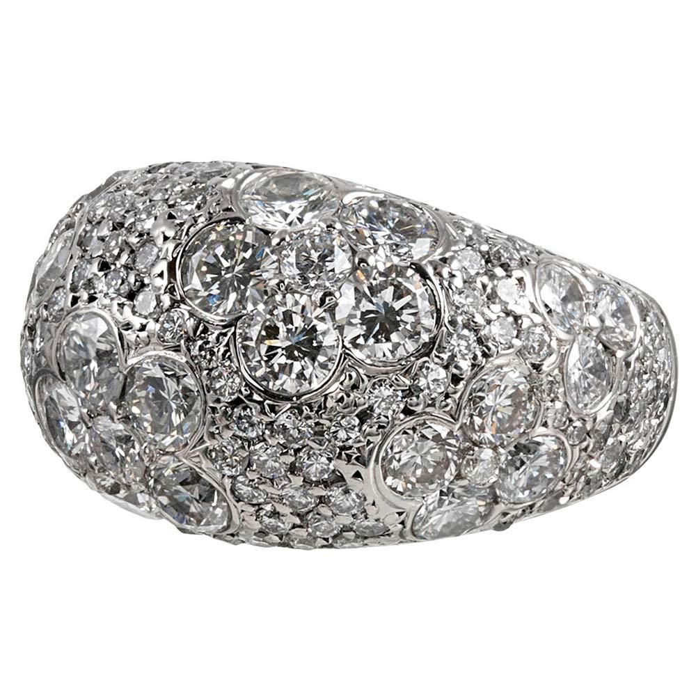 This substantial dome ring is made of platinum and contains 4.26 carats of brilliant white diamonds. Look closely to appreciate their assembly into flowers, with additional stones in the background, creating a never-ending stream of glittering