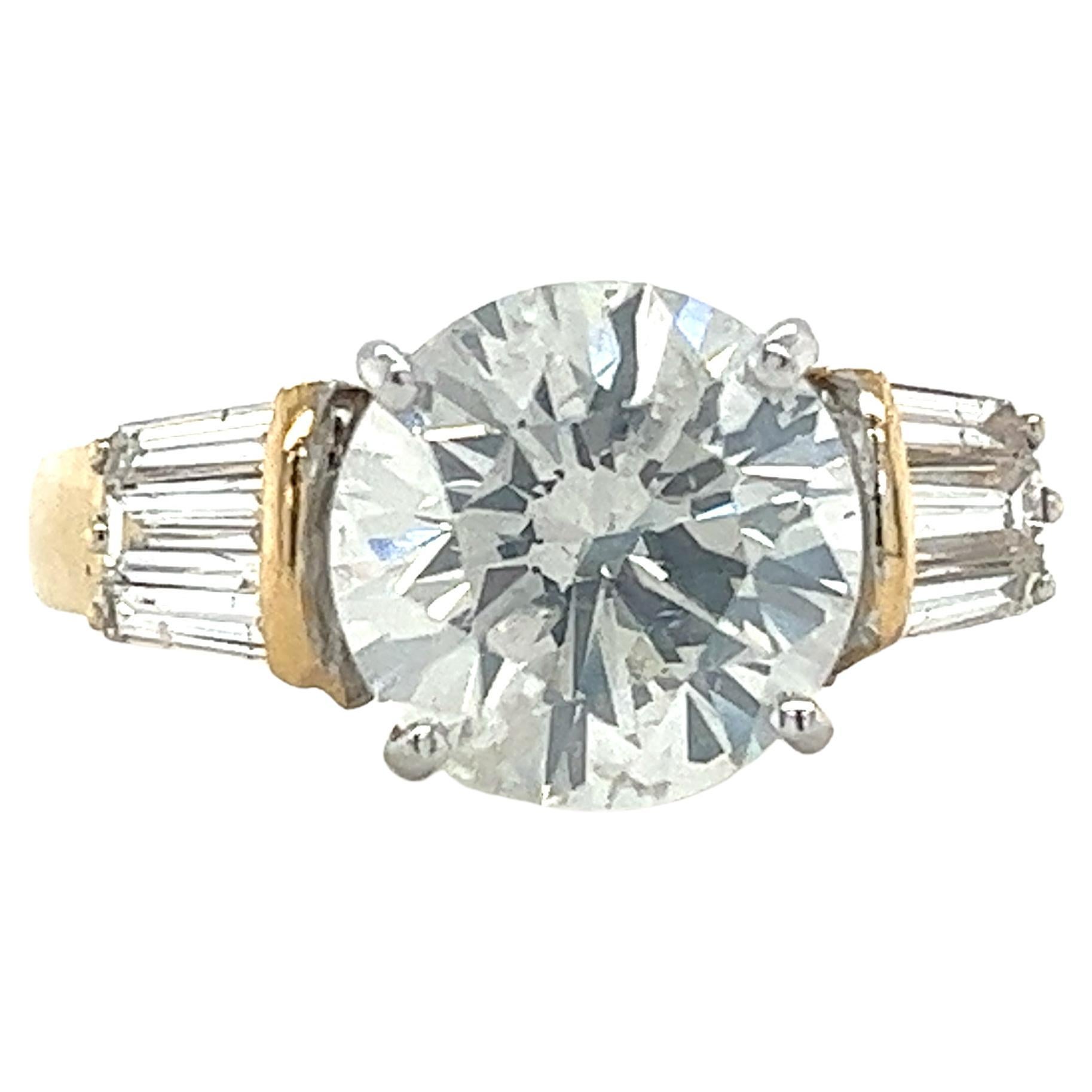 EGL certified 4.21 carat round cut natural diamond engagement ring. Set in a gorgeous two-tone 18k gold mounting. The center stone is adorned with 6 baguette-cut diamond side stones.

The center stone is a true bargain gem due to its details on