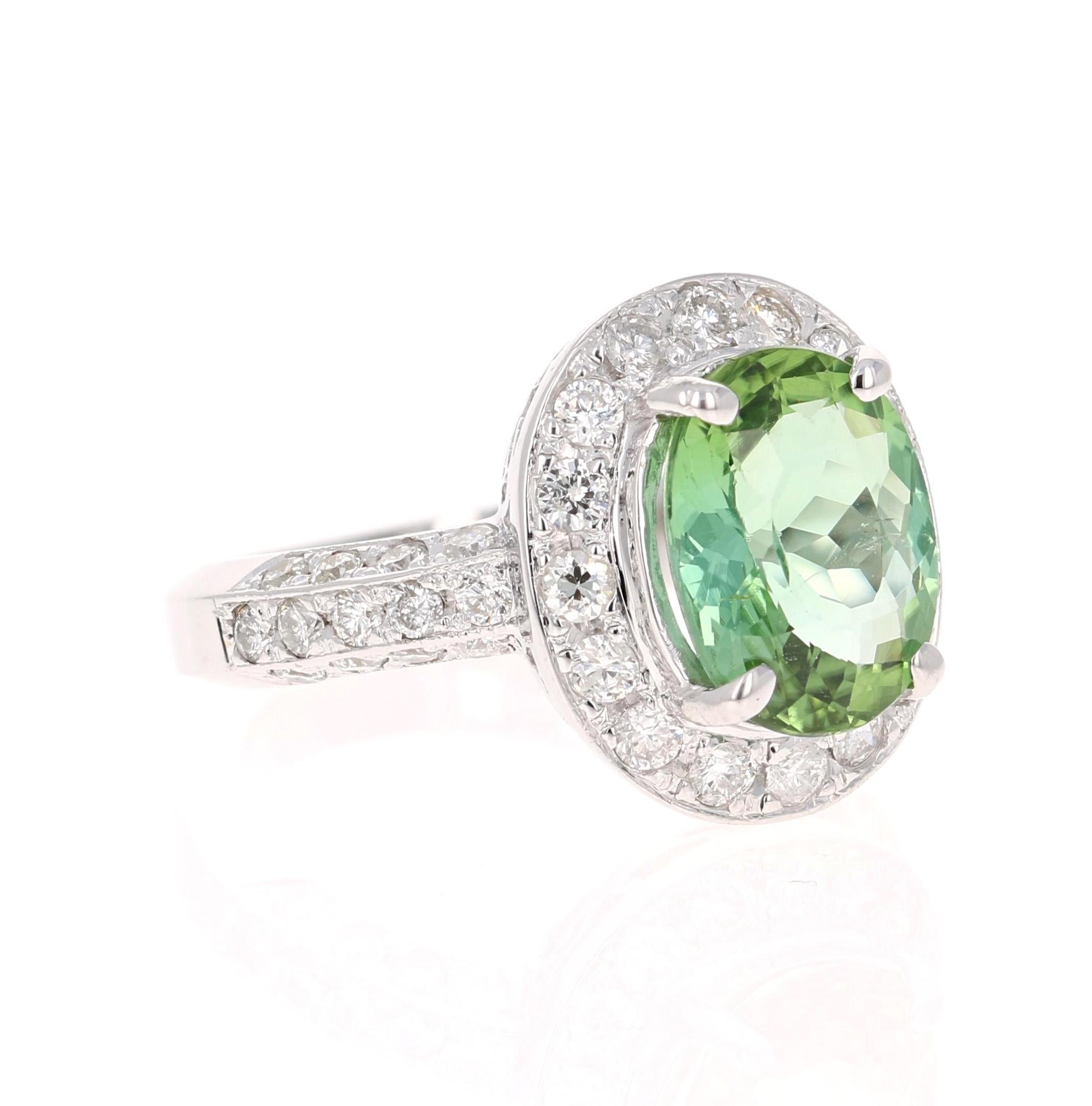 This stunner has a gorgeous Oval Cut leafy Mint Green Tourmaline that weighs 3.16 Carats. Surrounding the tourmaline are 42 Round Cut Diamonds that weigh 1.11 Carats. The Clarity and Color are SI-F.

The measurements of the oval tourmaline are 8 mm