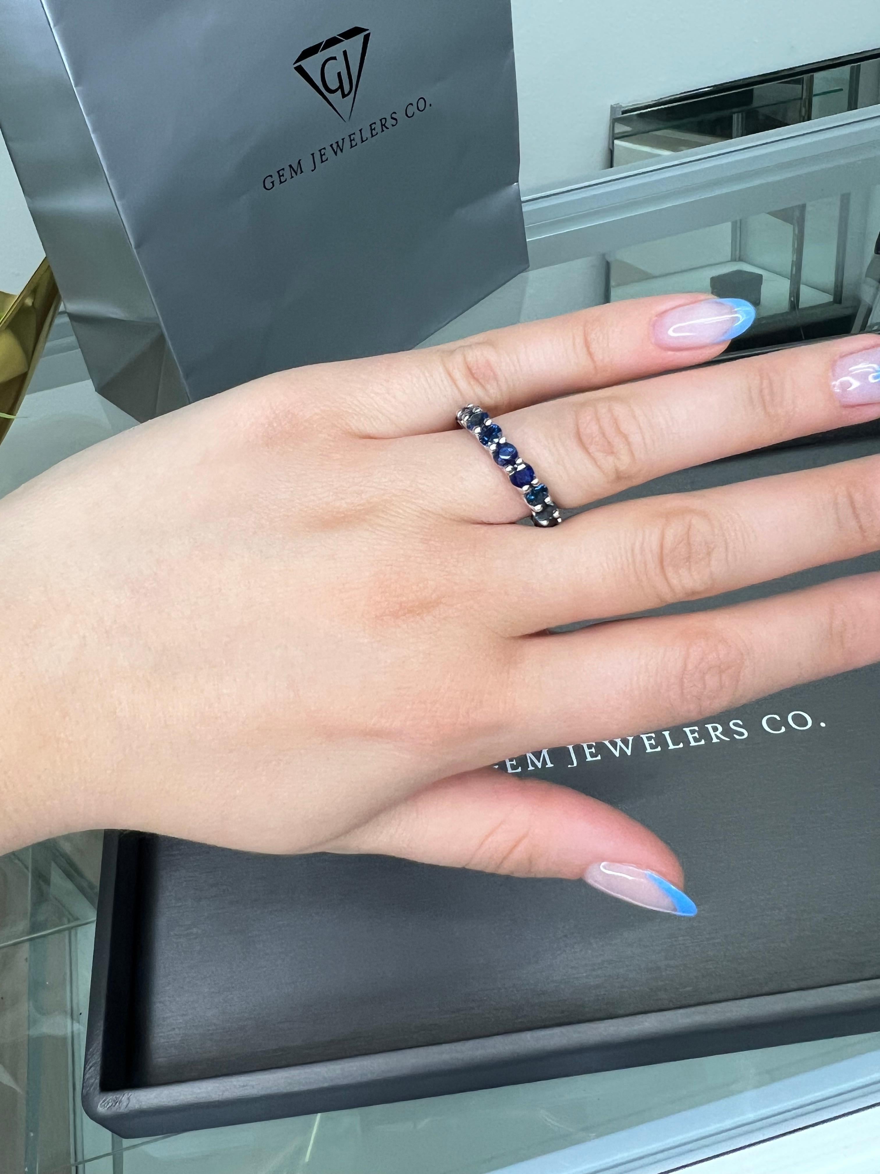 This Blue Sapphire Eternity Band by Gem Jewelers Co. is a must-have for any jewelry lover! Made with the finest 18K White Gold, this eternity band is not only beautiful but also built to last. With a dazzling row of  4.27 Carat Natural Blue