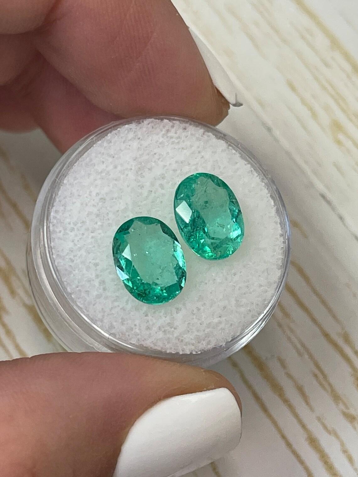 Stone: Emerald
Total Weight: 4.27-tcw
Shape: Oval Cut
Clarity: Transparent
Luster: Excellent-Very Good
Color: Bluish Green
Measurements: 10.08mm x 7.78mm x 5.18mm // 10.11mm x 7.72mm x 3.81mm
Geographic Origin: Colombia
Treatment: Natural,