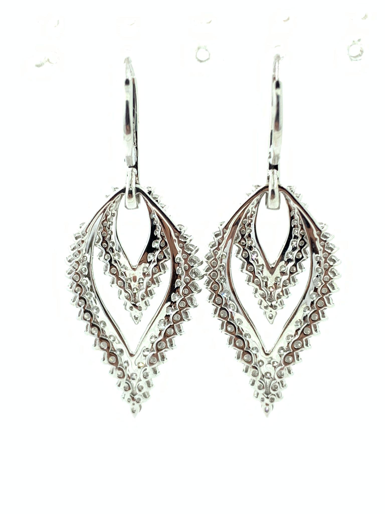 Looking for a pair of stunning earrings that exude luxury and elegance? Look no further than these dazzling earrings, crafted from 18 karat white gold and featuring a total of 4.28 carat of brilliance cut round pave diamonds.

Each earring is
