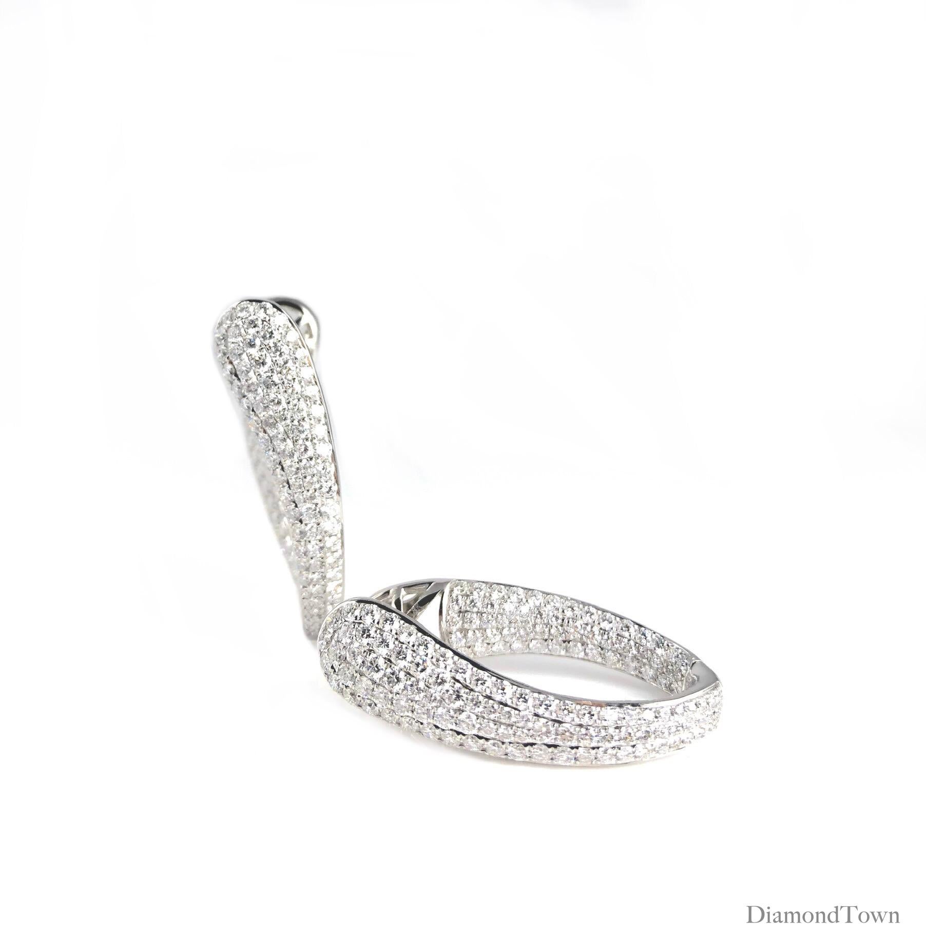 (DiamondTown) These sparkling hoop earrings shine with 4.28 carats of round diamonds adorning all the front-facing surfaces. Set in 18k White Gold. A modern look for a modern bride, or for the event of your choice!

Many of our items have matching