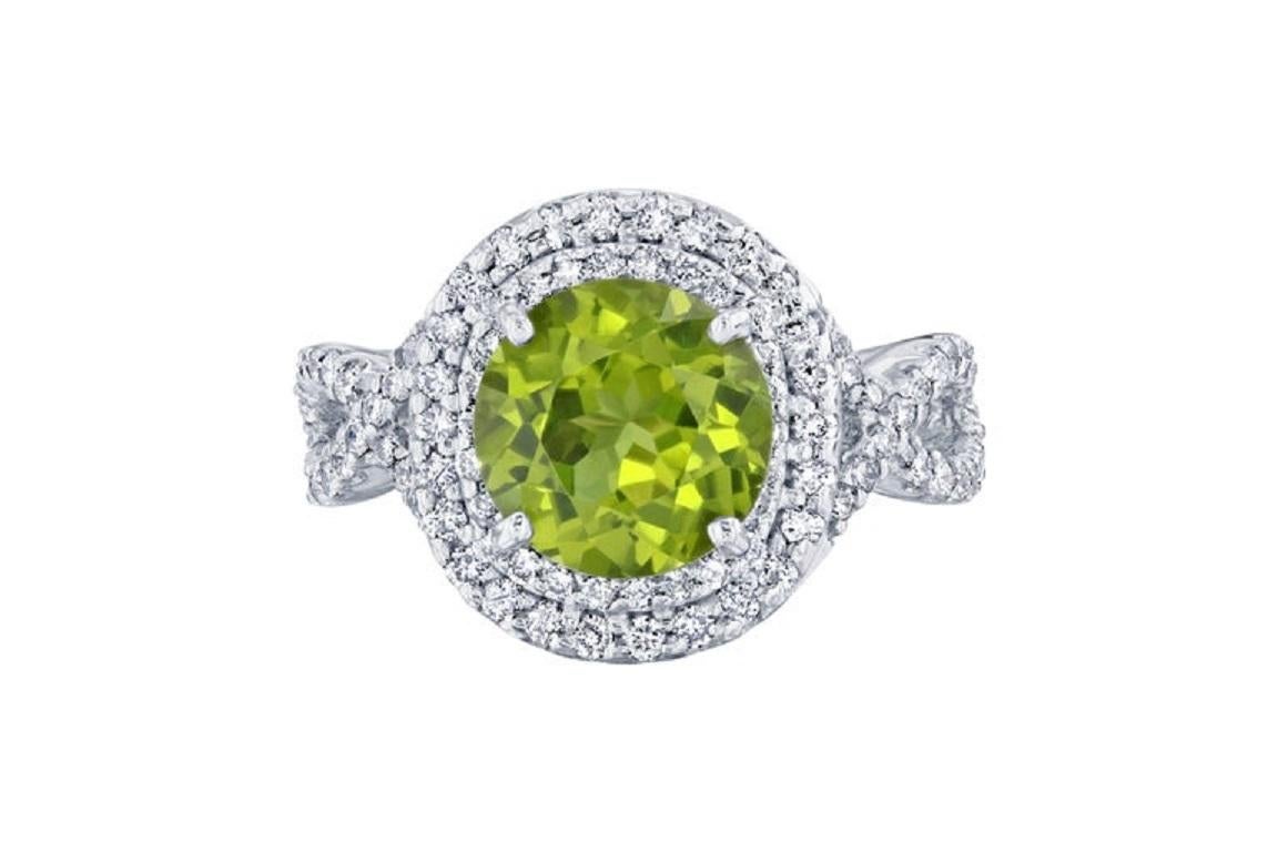 This has a large Round Cut Peridot in the center of the ring that weighs 3.45 carats.  The ring is surrounded by a double halo of 102 Round Cut Diamonds that weigh 0.83 carat.  The total carat weight of this ring is 4.28 carats.  The Round Cut