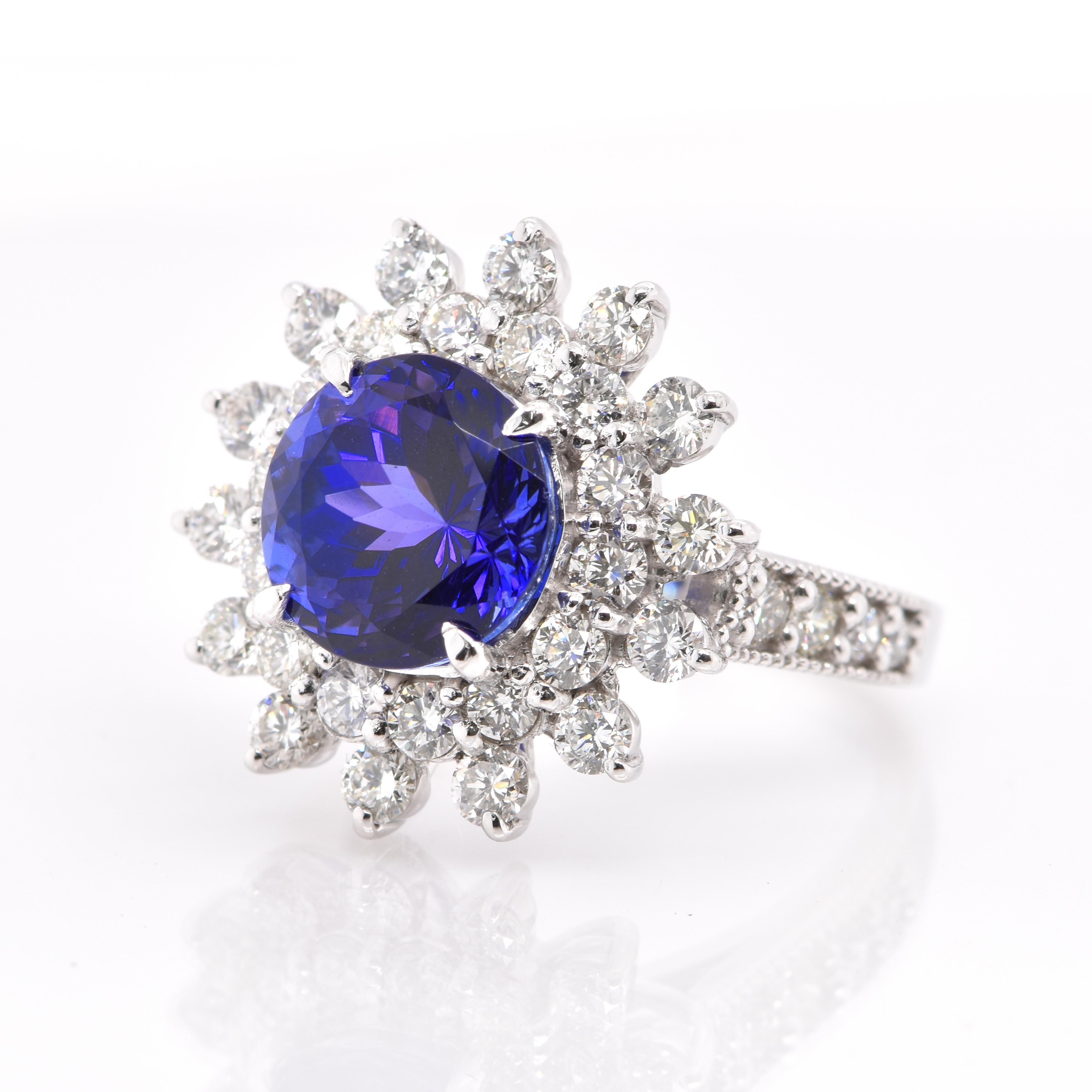 A beautiful Halo Cocktail Ring featuring a 4.29 Carat Natural Tanzanite and 1.78 Carats of Diamond Accents set in Platinum. Tanzanite's name was given by Tiffany and Co after its only known source: Tanzania. Tanzanite displays beautiful pleochroic