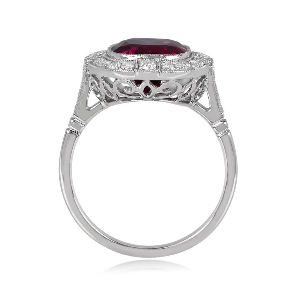 This captivating halo ring highlights a 4.29-carat rubellite, skillfully bezel-set and encircled by round brilliant cut diamonds. Additional diamonds grace the shoulders, leading to an openwork under-gallery. The ring's total diamond weight is